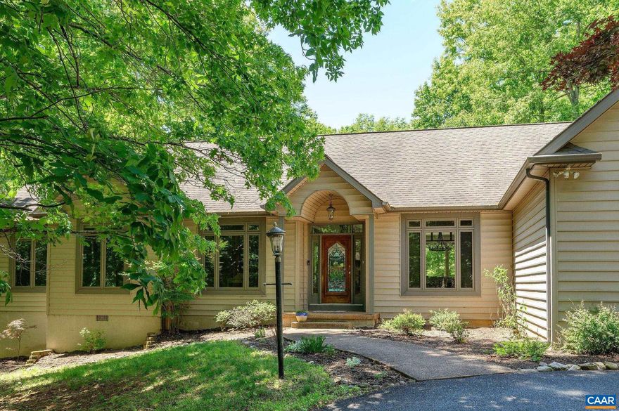 Set on a private 2-acre lot surrounded by woods in Fieldstone, this custom one-level home offers comfort, quality construction, and a peaceful setting in a very walkable neighborhood. Just minutes to I-64, Pantops, & an easy drive to Downtown Charlottesville and UVA. The open main living area features vaulted ceilings, a stone fireplace, and oversized thermal windows that fill the space with natural light. The newly remodeled kitchen includes quartz countertops, a gracious island, bright white cabinetry, and recessed lighting. Open floor plan flows seamlessly into the family room and breakfast nook. Step outside onto the screened porch and expansive deck?perfect for enjoying the fenced, sunny backyard. The sleek primary suite offers double closets and a completely renovated bath with soaking tub, double vanity, tile flooring, and a frameless glass shower. Thoughtful details such as crown molding, chair rail, and wood flooring add warmth throughout. A 2 car garage and bonus room allow for additional living options and plenty of storage . Energy-efficient geothermal HVAC.