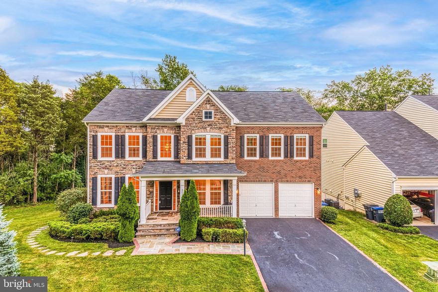 THIS IS THE OUTDOOR SPACE AND NEIGHBORHOOD YOU HAVE BEEN LOOKING FOR! Welcome home to this beautiful like-new 5 bedroom, 4.5 bathroom colonial in the very sought-after Marrwood community in Stone Ridge. Situated on a lovely corner lot, this home is perfect for outdoor entertaining -- the owner spent over $150,000 on the entire outdoor living space, including the  expansive natural stone patio featuring a wood-burning fireplace and FULL outdoor kitchen with built-in grill, sink and dishwasher. Inside this luxurious home, the open floor plan is filled with natural sunlight, with hardwood floors in the main living areas and soaring ceilings and oversized windows throughout. Enjoy preparing meals in the gourmet chef’s kitchen with granite countertops, high-end stainless steel appliances, oversized  island with pendant lighting and lovely upgraded 42” cabinets. Cozy up to the stone fireplace in the family room, and enjoy meals in the sunroom, opening up to the large Trex deck with LED lighting throughout, overlooking the wonderful wooded views. Upper level features a massive master suite with tray ceilings, his and her closets, bathroom with soaking tub, his and her vanities and separate shower. 3 more generous-sized bedrooms and 2 additional bathrooms with dual vanities complete the level. You will love the fully finished, walkout basement with rec room, full-sized wet bar, 5th bedroom and full bath -- would make a great in-law/au pair suite. Plenty of storage for coats and shoes in the large mudroom off of the 2 car/2 door garage with. Private and peaceful neighborhood but close to everything. Minutes to shopping, library, Brambleton Town Center, Rt 50, Rt 15 and Dulles Airport. All of the Stone Ridge amenities are yours to enjoy! Welcome home to Marrwood! Home is virtually staged in photos.