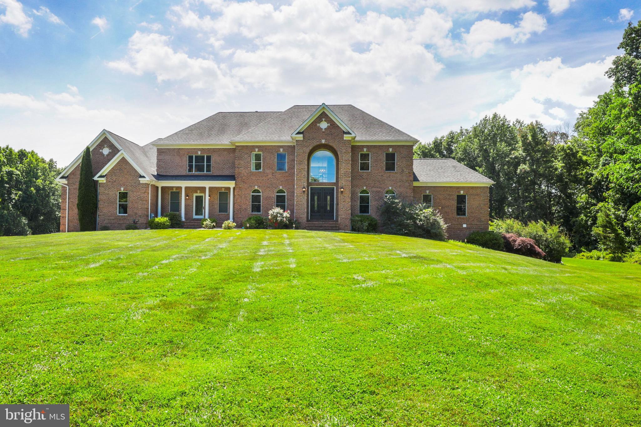ACTIVE UNDER CONTRACT. Beautifully updated 5 Bedroom, 6/3 Bath luxury home on 3 finished levels in great location with seasonal views of Liberty Reservoir. 2-story marble Foyer flanked by marble formal Dining Room and marble private Study. 2-story Great Room with fireplace and bar flows to incredible Kitchen with stainless steel appliances, commercial grade Wolf range, quartz counters and large sunny breakfast area. Main level Exercise Room and Playroom. 2 Powder Rooms, Laundry Room and Back Hall finish the main level. Stunning Primary Bedroom with fireplace and luxe Spa Bath with Air Tub, also with fireplace. 3 additional en-suite Bedrooms and Laundry Room complete the 2nd level. Spectacular walk-out lower level includes Rec Room with wet bar/kitchenette and fireplace, Home Theater, Bedroom 5 with Bath and Pool Bath/Changing Room with steam shower. Multi-tier Decks, covered Porches and Balconies overlook the heated in-ground Pool, Pavilion with cooking center and hot tub. 4-car Garage, large parking pad- all on 3.46 acres. Many 2021 updates!
