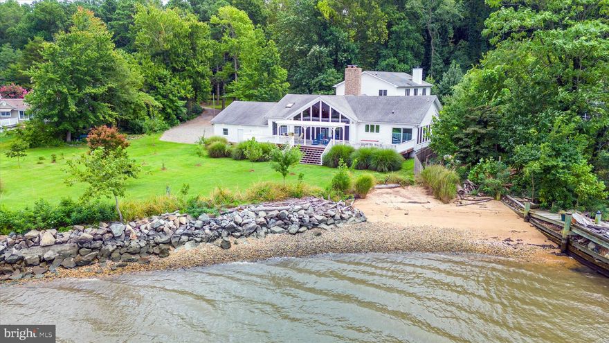 Welcome to your private Elk River waterfront paradise, nestled on 2.28 acres in Chesapeake City, MD! Affectionately known as “The Landing,” 87 Deer Run is a truly exceptional retreat featuring meticulously landscaped grounds, a rip-rapped shoreline, a sandy beach, and stunning sunset views over the water. Step inside and you’re greeted by a warm and inviting foyer accented by a propane fireplace. Just beyond lies the spectacular Great Room, showcasing a soaring cathedral ceiling, a stone fireplace with a wood-burning insert, and breathtaking panoramic views of the water—offering a front-row seat to ships passing through the Intracoastal Waterway. The updated kitchen is a chef’s delight, featuring granite countertops, tile flooring, canvas cabinetry, and a spacious walk-in pantry. Dine in the sunroom or in the Great Room’s dining area, both of which offer sweeping views of the river. The primary suite includes a generous walk-in closet and a beautifully remodeled en-suite bath (2023). Two additional bedrooms—one with water views—and a second full bathroom complete the main level. Outside, an expansive Trex deck with a large pergola sets the stage for unforgettable outdoor living. Whether dining, entertaining, or simply relaxing, you’ll enjoy endless views and the serene sights and sounds of nature. Upstairs, a private guest suite offers an open-concept layout with a sleeping area, living room with propane fireplace, dining space, and a full kitchen with water views—plus a large closet and a full bath, making it perfect for extended stays or multi-generational living. Storage is plentiful with two oversized two-car garages—one featuring a 10’x18’ door and ample storage, and the other with an 8’x18’ door—ideal for vehicles, watercraft, or a workshop. A spacious circular driveway provides convenient parking for all your guests. Additional thoughtful upgrades include a BAT septic system and brand-new mini splits on the main level (2024). Just minutes from charming downtown Chesapeake City, you’ll enjoy easy access to waterfront dining, local events, and boutique shopping. Don’t miss this rare opportunity to own a one-of-a-kind waterfront gem on the Elk River!