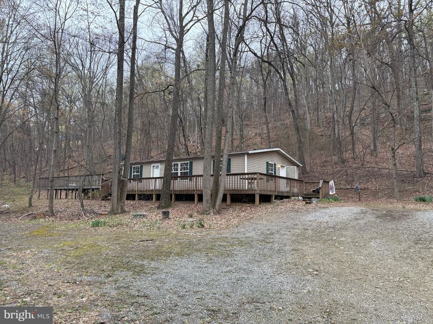 11.22 Unrestricted Acres with well and septic.  Enjoy the private location!   This doublewide home on a crawlspace needs someone to love it.   Being sold AS IS to a cash buyer!