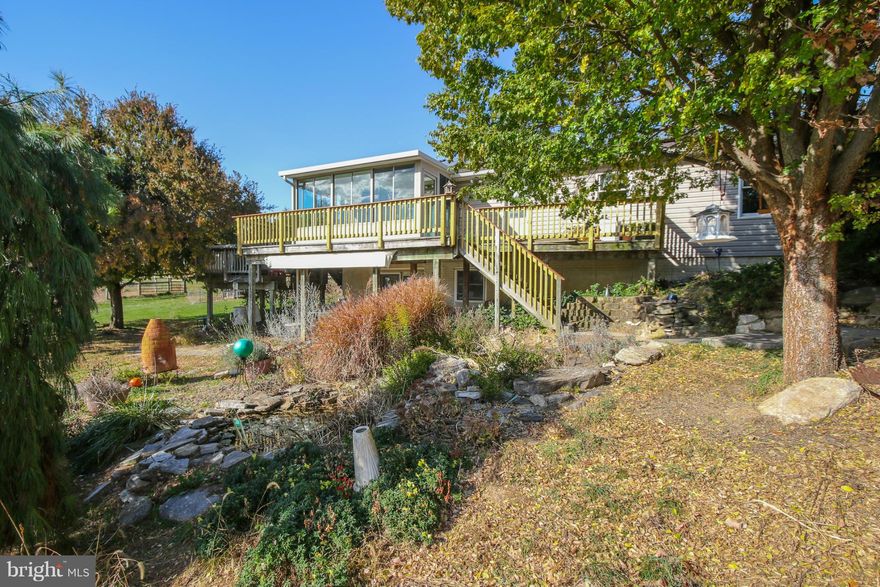 Buyers financing fell thru!  Welcoming gardens & coy ponds! Fenced pastures & pathways to ride or walk throughout this lovely property! Barn w/water & electric!  Greenhouse & chicken coop too! Relax & enjoy the large pond w/aerator system!  Solar panels on house (owned) keep electricity costs to a minimum!  Sunroom/sitting room off master!  Stainless appliances!  Nice property!