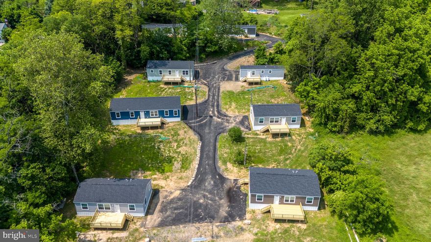 Royal Manor Village is a rare investment opportunity offering both immediate income and investor-preference flexibility, all set in a peaceful private location with beautiful long-distance views. Ideally located just 10 minutes to both Bethlehem and Easton, and only 5 minutes to I-78, the property provides convenient access to major routes while maintaining a quiet, rural atmosphere. This property is located close to a variety of recreation opportunities, including the Delaware River and Canal, Fry’s Run Park, and Mariton Wildlife Sanctuary, making it attractive to both residents and future buyers. The property includes two tenant-occupied, stick-built single-family homes with current leases in place, providing stable, ongoing cash flow from day one. In addition, there are eight brand-new manufactured homes that are move-in ready but currently unoccupied, giving the new owner a blank canvas to maximize returns. Whether you choose to rent all ten homes or sell the individual homes while retaining ownership of the lots to collect lot rents, the flexibility of this property is unmatched. The infrastructure has been completely redone, including a newly paved private roadway and an upgraded septic system, minimizing future capital needs and ensuring low-maintenance operations. With a projected gross income of $225,700 per year, Royal Manor Village is ideal for an investor looking to add a high-yielding asset to their portfolio while benefiting from a fully modernized setup in a highly desirable setting.