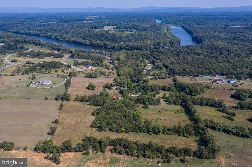 This perfect gentleman's farmette with a tastefully restored historic log home sets on gorgeous, private grounds with awesome outbuildings that include a barn, spring house, detached garage, potting sheds, run in shed and grazing areas, plus an inground pool, all sited on 25+ unrestricted acres, deeded in 2 parcels.  The home has all the features you hope to see in a home of this period but also suit a contemporary lifestyle.   Live, work and play from home....have a business venture?  The possibilities are endless and the location is exceptional! Property has cider apple trees planted for selling or have your own "cidery".  Looking for an event center. The barn can be turned into a spectacular amenity.  Several other buildings on site, for "tiny" house stay or ABNB the current residence and offer a variety of other ventures.  Plant crops to harvest or lease land to an organic crop grower and offer space for a small onsite store.  Second parcel currently carries farm tax rate.  This property also has the ability to subdivide the second parcel and recoup your investment or build another home.  A family compound perhaps! What's your vision!
