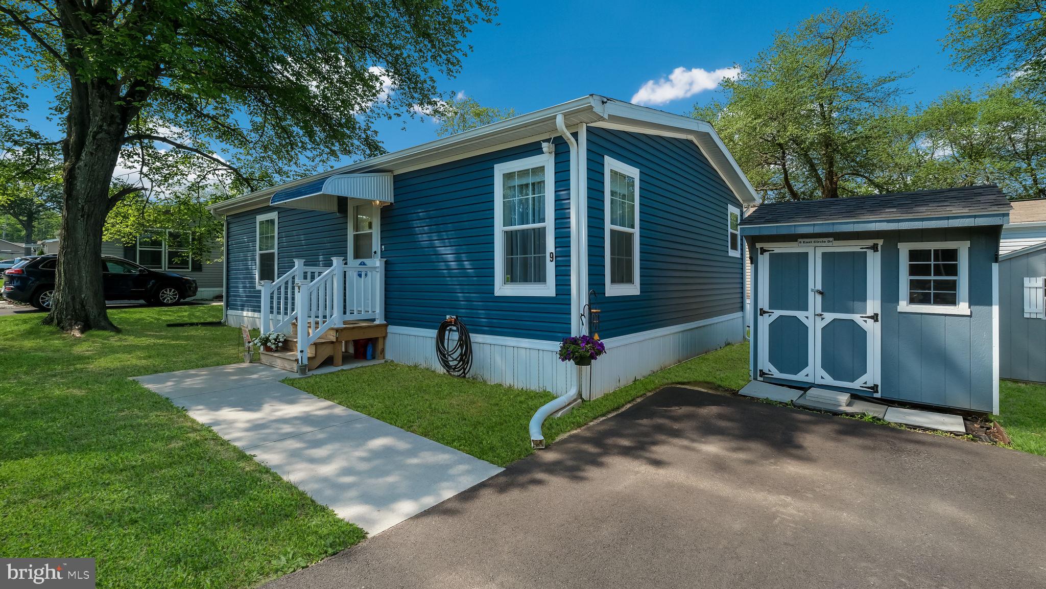 Why rent when you can own this beautifully upgraded, newer 2-bedroom manufactured home for just $145,000 ,
** SELLER INCENTIVE: $300 monthly credit for your first 6 months – that’s $1,800 toward ground rent to ease you in! Colonial Heritage welcomes all ages! This charming 2-bedroom home built in 2023, boasts a timeless colonial blue exterior with crisp white trim, complemented by a private driveway and large storage shed that matches the color of the home for a seamless, cohesive look. Recent updates include front and rear exterior awnings, secure storm doors, and security cameras, ensuring both style and peace of mind. Upon entering, you’re greeted by an open-concept living space that flows seamlessly into a well-appointed kitchen featuring stainless steel appliances, a ceramic backsplash, and elegant cabinetry. The kitchen island, complete with a breakfast bar, provides additional workspace and a perfect spot for casual dining. Adjacent to the kitchen, a spacious dining area offers ample room for meals and entertaining. A hallway leads to a full-size laundry room, complete with a separate washer and dryer and overhead shelving for added storage. The room’s exit door leads to the yard, enhancing convenience. The master bedroom is equipped with a ceiling fan and double-door closets, while the second bedroom offers a comfortable size and additional closet space. The luxurious bathroom features a walk-in shower and a bidet, providing a modern and functional retreat. A large linen closet further enhances the home's storage options. The development of Colonial Heritage is conveniently located in beautiful Doylestown Township near major transportation arteries, offering easy access to commuting routes, shopping/dining and entertainment. Colonial Heritage--is not an age restricted community--and is located in the Blue Ribbon School District of Central Bucks School System. This truly is a charming place to call home--you won't be disappointed!