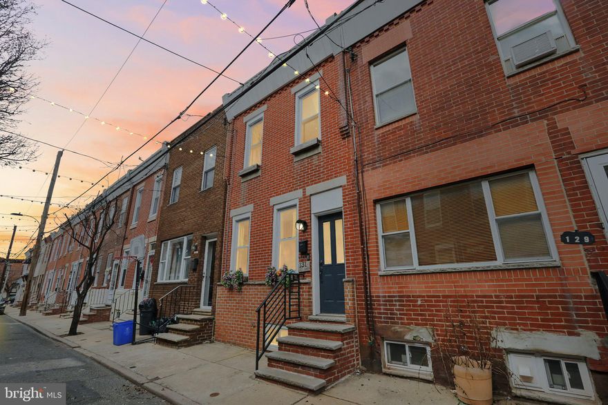 Welcome to 131 Mercy Street! Nestled on one of the most coveted blocks in South Philly, this charming home offers the perfect blend of convenience, character, and modern comfort. Located in a neighborhood that truly has it all, you'll enjoy easy parking in a well-known, highly desirable pocket of the city.

As you approach, stroll beneath the twinkling lights strung above the street, creating a welcoming atmosphere that leads you to this beautifully renovated 3-bedroom, 2-bathroom home. Upon entering, you’ll be greeted by the striking exposed brick wall, complemented by a stylish modern feature wall—a perfect mix of old-world charm and contemporary design. A thoughtfully placed half-bath on the first floor ensures comfort and privacy for both you and your guests.

Towards the back of the first floor, you'll discover a spacious, well-maintained eat-in kitchen, complete with a fun chalkboard wall—a perfect space for everyday meals or entertaining. Head downstairs to find a cozy, partially finished basement, featuring a charming wine cellar ideal for wine enthusiasts.

On the second floor, three bright and airy bedrooms await, along with a full bathroom that’s bathed in natural light. For added relaxation, step outside to the medium-sized back patio, offering a peaceful outdoor retreat right in the heart of the city.

Your new home is just a short walk from public transportation, a variety of dining options, shops, and attractions like the Bok Building and East Passyunk Avenue. It’s the perfect spot to experience the best of South Philly!