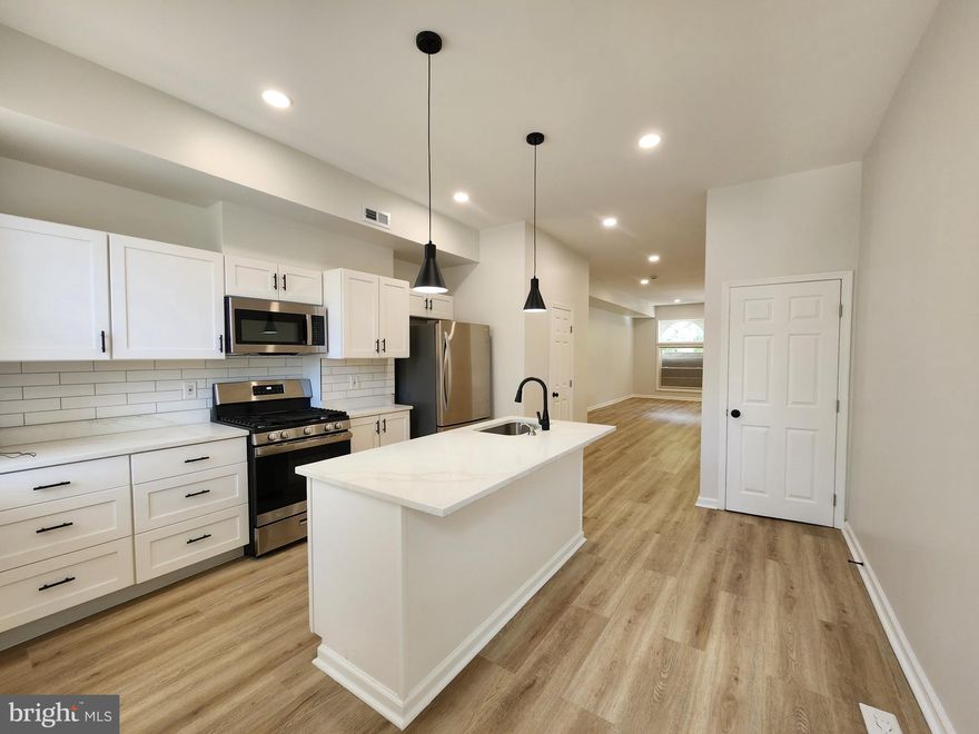 Come see this totally renovated spacious light filled home in near historic Madison Park. This gem has recessed lights in its tall ceilings that accents perfectly the new floors throughout. The stainless steel appliances glow in the modern style  kitchen that boasts an open floor plan. Enjoy the large lower level in the winter time or relax in the huge courtyard in the rear with its concreted parking pad. Ground rent unknown seller will not redeem.