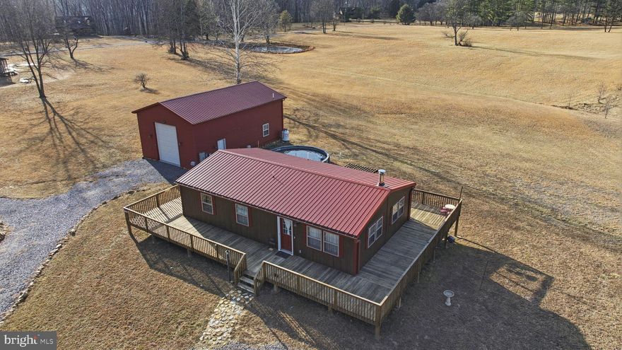 We have found what you are looking for, a home that is easy to maintain and a garage that will hold all your recreational needs. Take the time to look at this cozy cabin and move in before spring so you can enjoy the beautiful Cacapon River.  This home has sliding doors, hickory cabinets, stainless steel appliances, oh and an elevator in the home and in the garage. Elevator in the home will take you to the finished lower level where the floors are heated..  And there is more, wrap around deck leading to an above ground heated pool with the beautiful view from the back yard, and to the oversized garage with camper/ RV hookups, full bathroom and an extra room.  One more thing.. IT IS FOR SALE UNDER APPRAISED VALUE