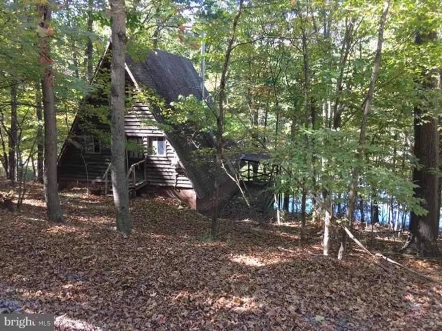 Selling A Frame on 2 lots consisting of 1.18 acres of lake front property.This beautiful property has not been used for many years.Sits on the lake with mountain views. Path and steps right to the beach area and dock.A frame has 2 main levels and a loft. Has 2 large decks on the lake side. The A frame is on the first parcel. This is being sold As Is but has much potential and great location.