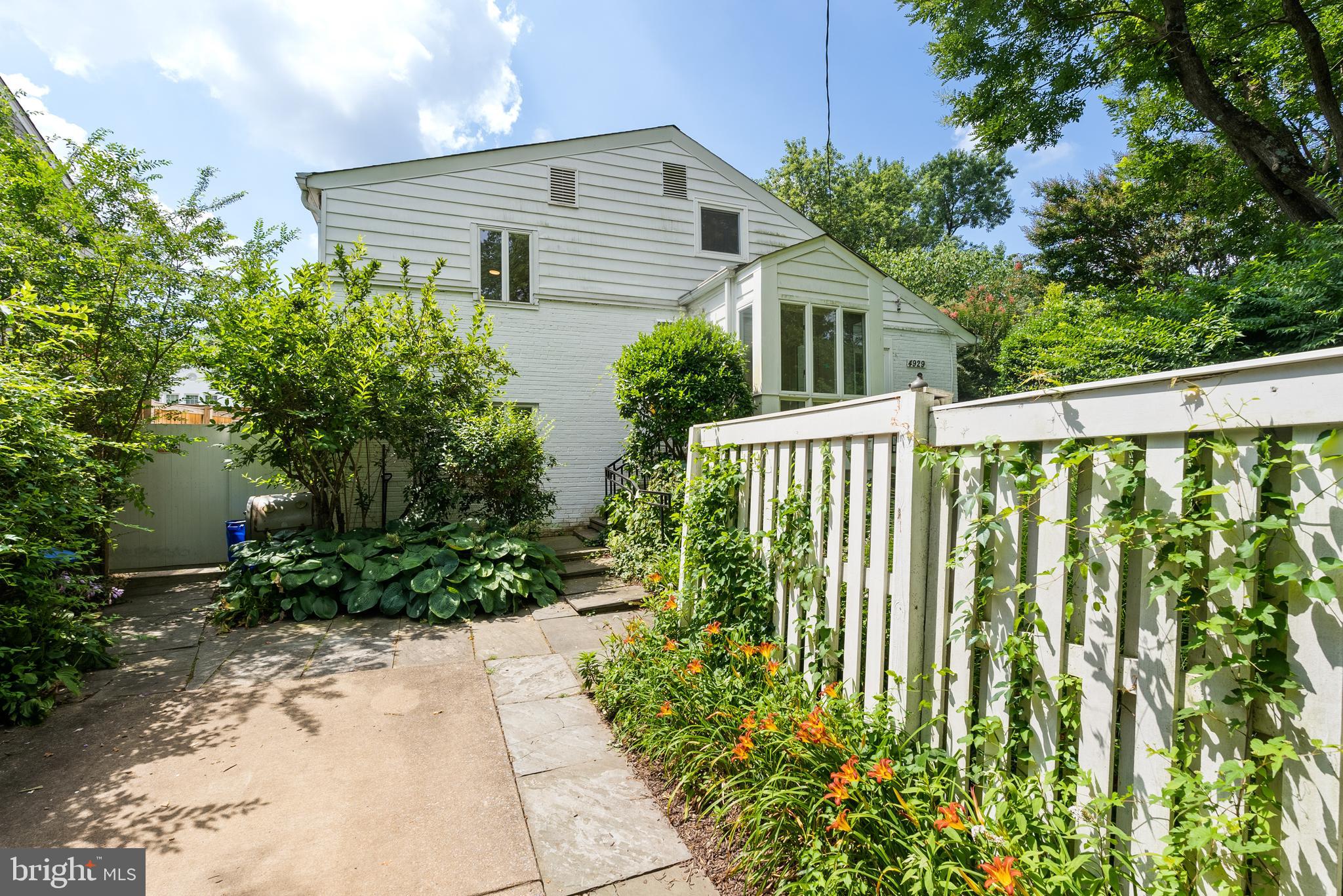 Bright. Airy. Special. Welcome to this captivating contemporary home tucked onto a private, corner lot in the heart of the beloved Westgate neighborhood of Bethesda, just steps to Washington, D.C.
Thoughtfully designed for modern living, this 4BR, 4.5BA home blends clean architectural lines with light-filled interiors and effortless flow. Cathedral ceilings, oversized windows, and the lushly landscaped lot create a harmonious connection between indoor and outdoor spaces, offering a serene retreat just minutes from the heart of the city.
The open-concept main level centers around a vaulted family room that flows into the dining area and sleek kitchen, complete with a breakfast bar, table space, state-of-the-art appliances, and expansive windows that bring the outside in. A custom mudroom entry, off the driveway, ensures easy transitions.
The main level also includes a formal living room, home office, den (or second home office), powder room, a large en suite bedroom with full bath and laundry room.
Upstairs, the spacious primary suite features an en suite bath and a private sitting room. An additional bedroom offers its own lounge area (used as a teen retreat for studying and gaming), walk-in closet, and full bath. The lower level includes a rec room (or fourth bedroom), full bath, and storage. The space is perfect for guests or recreation.
The corner lot is marked by lush gardens, stone patios, a charming pergola, along with a driveway for off-street parking.
Westbrook Elementary, Westland Middle, and B-CC High (with IB curriculum) serve the neighborhood, while local parochial and private schools are close by.
Located just moments to Spring Valley (DC), Friendship Heights, and Embassy Row, the property offers exceptional access to downtown Washington, D.C., Bethesda, Arlington, McLean, and Rockville. Convenient to the Capital Crescent Trail, Westbard Square, Tenleytown and Metro.
Whether you're relocating from abroad, across the country, or within the neighborhood, 4929 Jamestown Road offers a rare blend of elevated design, flexible living, and one of the most connected addresses in the Washington metropolitan area.