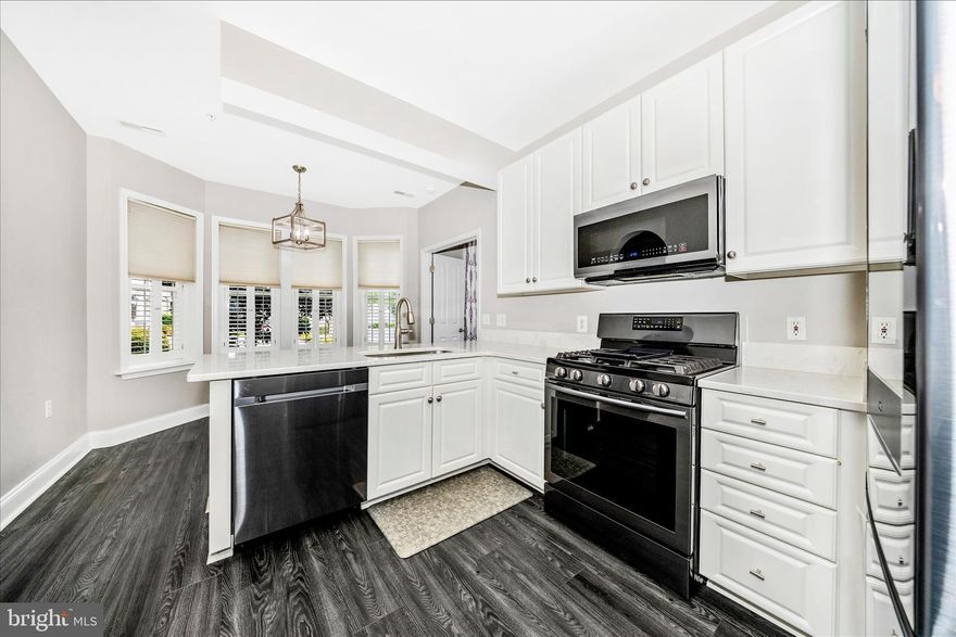 Discover an exquisite lifestyle in the heart of Wormans Mill, where luxury meets comfort in this stunning 2-bedroom, 2.5-bathroom first floor unit. Spanning 1,362 square feet, this residence is designed for those who appreciate the finer things in life, offering an open floor plan that seamlessly blends elegance with functionality. Step inside to find a beautifully appointed kitchen, featuring a breakfast area perfect for casual dining and entertaining. Equipped with high-end stainless steel appliances, including a gas oven/range, dishwasher, microwave, and refrigerator, this culinary haven invites you to unleash your inner chef. The kitchen's table space is ideal for intimate meals, while the adjoining dining area sets the stage for more formal gatherings. This unit's unique position to the daily sun movement creates natural light which floods the living spaces through bay and bow windows, enhancing the inviting atmosphere. The spacious living room, complete with a cozy fireplace, serves as the perfect backdrop for relaxation or entertaining guests. Retreat to the primary suite, a sanctuary of tranquility featuring an en-suite bath designed for indulgence. With modern fixtures and ample space, this private oasis offers a perfect escape from the hustle and bustle of daily life. This unit also boasts convenient features such as an entry-level bedroom, window treatments for added privacy, and a dedicated laundry area with washer and dryer. Security is paramount, with a fire detection system, smoke detectors, and a main entrance lock ensuring peace of mind. Step outside to enjoy your own private patio or porch, perfect for morning coffee or evening relaxation. The community amenities elevate your lifestyle further, offering access to outdoor pools, tennis courts and a clubhouse. Explore the scenic bike trails or unwind at the putting green-there's something for everyone.  The meticulously maintained grounds and community features create an unparalleled living experienc. Embrace the opportunity to live in luxury at Wormans Mill, where every detail has been thoughtfully curated for your enjoyment. This is more than a residence; it's a place to create lasting memories.