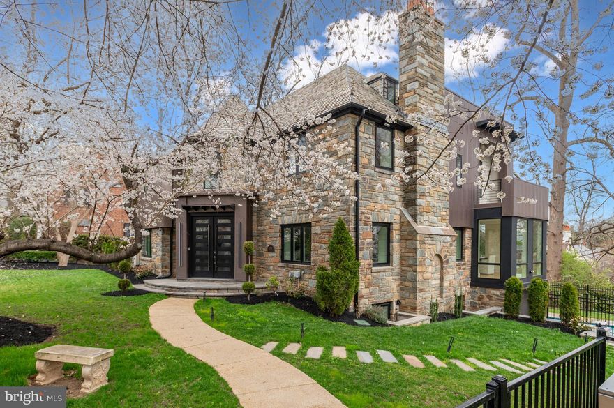 Welcome to 3001 Foxhall Rd NW, a masterful reinvention of a Tudor Revival by 3G Architects in 2024  located on a corner lot along a tree lined stretch of Foxhall Road. Beyond its storied façade, more than 7,300 square feet unfold across four meticulously curated levels—where heritage architecture meets bold, modern clarity.

A grand 18-foot foyer sets a dramatic tone, introducing wide-plank white oak floors, tailored millwork, and a restrained material palette that feels at once timeless and forward-thinking. The formal reception room, anchored by a sleek wet bar, transitions effortlessly to a gracious living room and an elegant dining room—both overlooking the sculptural pool and manicured gardens beyond.

At the rear of the home, walls of triple-paned, floor-to-ceiling glass dissolve the boundary between indoors and out. The kitchen and family room form a luminous, gallery-like expanse designed for both grand entertaining and intimate daily rituals, featuring a 60” fireplace. A monolithic center island commands attention, complemented by a 48-inch Miele dual-fuel range, integrated wine refrigeration, espresso station, and bespoke Ultralux cabinetry. A discreet command center, walk-in pantry, powder room, and a main-level guest suite or office complete the floor with intention and ease.

Upstairs, three secondary bedrooms offer serene proportions, each with ensuite baths and generous storage, including walk-in closets. The primary suite is conceived as a private retreat: a skylit sitting room with a two-sided fireplace, wet bar, and secluded balcony precede a spa-caliber bath featuring a soaking tub, steam shower, and expansive dressing room with dual walk-in closets. Completing this level is a bonus hang out space, perfect for relaxing before bed. 

The top floor reveals a flexible loft space, perfect for a home office, yoga room, or kid’s play room.  Finishing out the interior of the home is the expansive lower level that is great for both everyday living and entertaining—with a second kitchen and wine cooler with space for 212 bottles, circular game room, media lounge, sixth bedroom, full bath, and additional laundry.

An oversized, heated three-car garage provides a rare dual access driveway to both Foxhall Road and Hawthorne Street. Outdoors, a 39-foot heated pool with waterfall takes center stage, framed by layered terraces, a full pool bath, and a cabana cooled by ceiling fans—all enveloped in lush, fully fenced landscaping.

Moments from Georgetown, The Palisades, and the boutiques and dining along New Mexico Avenue, 3001 Foxhall Road NW is a rare composition of history, design, and uncompromising modern luxury.