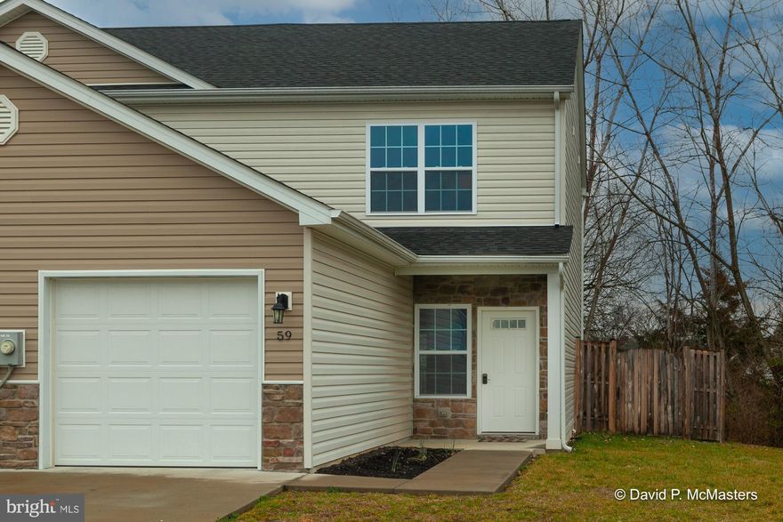 Modern design, easy living duplex is move in ready, offering LVP flooring and fresh paint throughout!  Covered front porch leads to the welcoming and open main level featuring spacious and bright living room with garage access.  The sleek eat-in kitchen offers granite countertops, dark cabinets, black appliances, and window above the sink.  Rear patio and fenced rear yard are conveniently accessed from the dining area.  Large walk-in pantry and half bathroom along the wide walkway between kitchen and living room complete the main level.   The carpeted stairs lead to double primary bedrooms, each with private full bathrooms, vaulted ceilings, and large closet. Laundry closet also located on the upper level.  Entry level one car garage comes with garage opener and personal driveway parking.  Situated on cul-de-sac lot location in South Berkeley County, minutes from I-81 and Virginia!