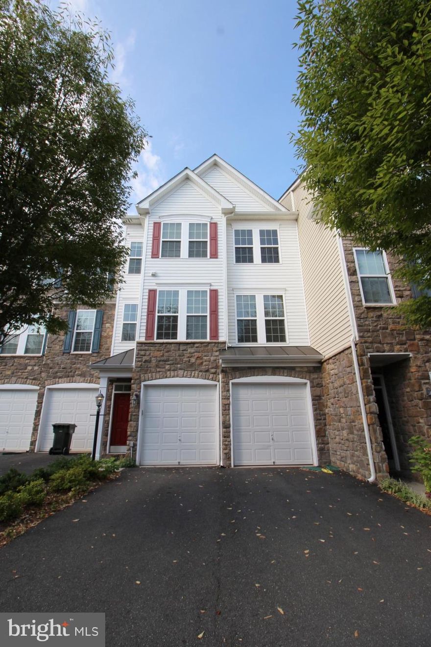 NICE VIEW! Tri-level Townhome with one car garage offering gleaming wood floors in the main areas, gorgeous kitchen with updated stainless steel appliances, granite, recessed lighting, and large kitchen island. Dual sinks in a shared bath and master bath! Tons of outdoor living space with 2 decks that back up to walking paths and a pond. Rec room with wet bar and more! This one won't last long! Trash included in association fees! Fireplace is decorative.