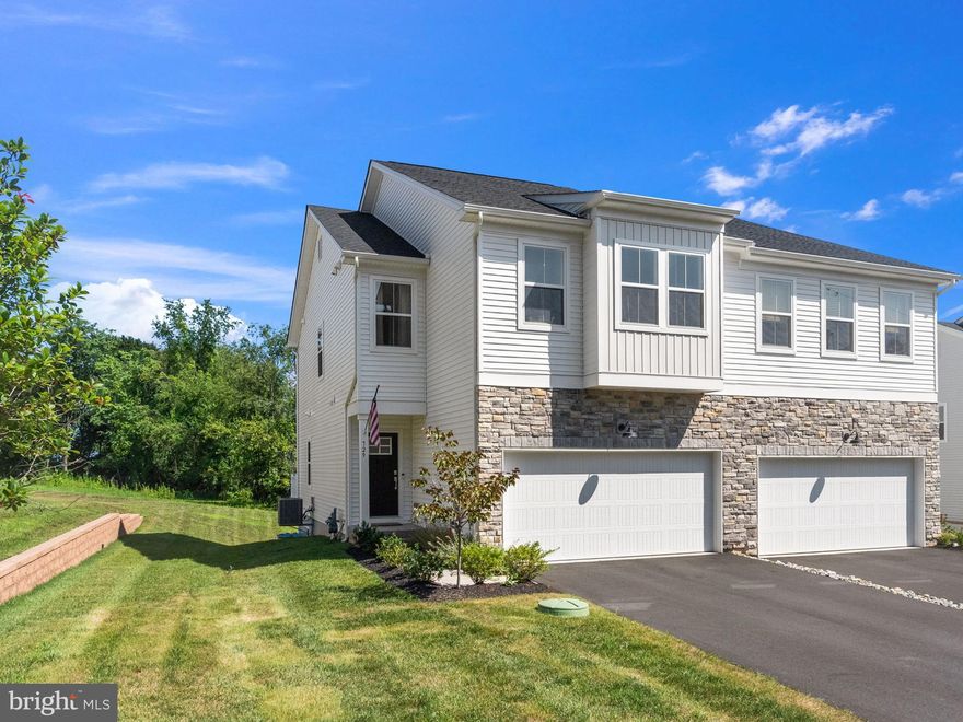 Welcome to 729 Hunsberger Rd! An elegant, turnkey carriage home in the highly sought-after Villages at Spring Hill in Spring City. Just 1.5 years young and impeccably maintained, this home offers the feel of new construction without the wait.
Step inside to three levels of bright, thoughtfully designed living space. Immediately after settlement, the seller upgraded the upstairs carpeting to match the flooring on the main level, creating a seamless and cohesive aesthetic throughout.
The main level showcases a beautiful open-concept layout with 9-foot ceilings and effortless flow between the kitchen, dining area, great room, and morning room. A gas fireplace anchors the living space, while sliding doors off the dining area lead to a composite deck overlooking open space. Perfect for relaxing evenings or entertaining guests.
The kitchen is both stylish and functional, featuring soft-close white cabinetry, quartz countertops, a subway tile backsplash, recessed lighting, a spacious island, and a pantry. A powder room, coat closet, and interior access to the 2-car garage complete the main level.
Upstairs, wood-tread turned stairs lead to a versatile loft area ideal for a home office or additional lounge space. The primary suite includes recessed lighting, a generous walk-in closet, and a beautifully appointed en-suite bath with double vanity, tiled shower surround, linen closet and tile flooring.
Two additional bedrooms, each with walk-in closets, and a full hall bath with tile flooring and subway tile tub surround, a linen closet, and a full laundry room provide comfort and convenience on the upper level.
The fully finished basement expands your living space with plush carpeting, a second half bath, and a large open area perfect for a media room, fitness space, or playroom. An egress window, under-stair storage, and a spacious utility/storage room featuring a tankless hot water heater add both functionality and flexibility.
Ideally located just minutes from vibrant downtown Phoenixville, known for its dining, shopping and entertainment, and offering easy access to major routes, this home provides exceptional convenience. Enjoy nearby access to the Schuylkill River Trail, local parks, and a short drive to Philadelphia and King of Prussia.  Spring-Ford School District! 
This home truly delivers the perfect blend of modern style, low-maintenance living, and prime location.