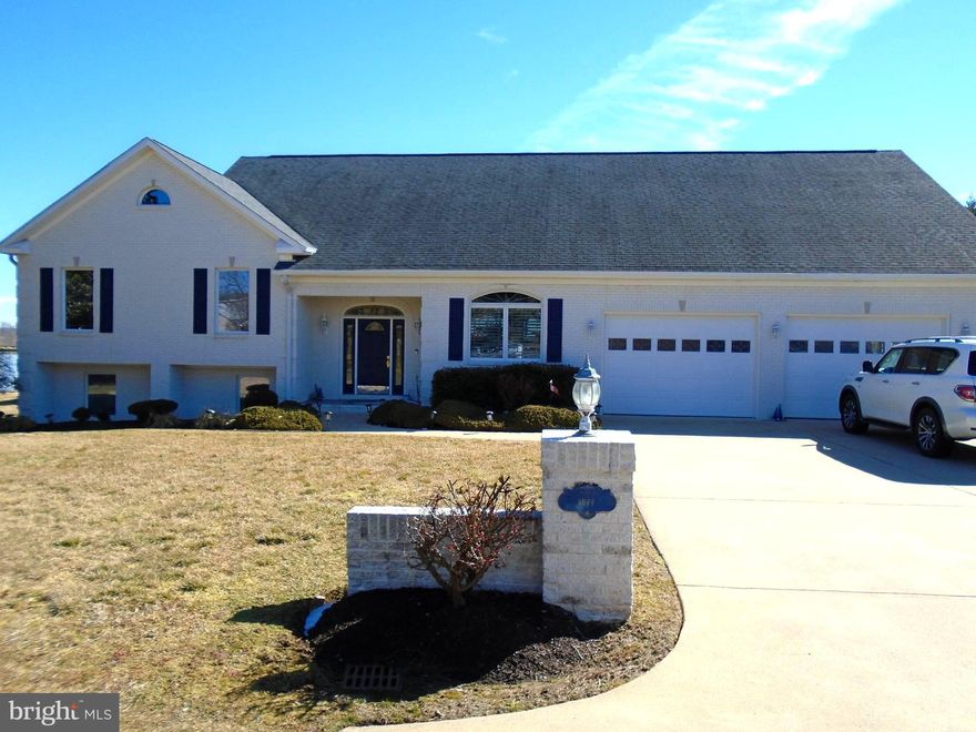 HUGE PRICE DROP!!  Live at the BEACH,* WATERFRONT  ** Very few true WATERFRONT properties in NOVA.  You own 260 feet of bulk headed, navigable waterfront with your own dock.  Two boat lift slips, two jet ski lifts.  Gorgeous Potomac River 180 degree views!  Watch the Moon rise from your luxury soaking tub, or your screened in sun porch or even from your private, enclosed Gazebo.  Or just look out almost any window and see the Moon over the River.  And what better view with your coffee than to watch the Sun come up and light up the River and Sky!  So gorgeous.  Three lots combined into one for just over an ACRE of PRIME WATERFRONT.  One lot could be divided and the Tap Fee has already been paid!  Or use that lot to park your Motor Home or play Pickle Ball on an asphalt pad court.  Has been used for both by current owner.    Did I mention the Brick, Enclosed Gazebo with its own screened sitting area.  Wet Bar and all.  Perfect for those weekly card games or for when entertaining family and friends on your own private beach and pier.  Dock your boat at your backdoor.  Keep your jet skies on their own lifts.  Enjoy the landscaped walks all around the house.  The outside yard and waterfront are worth the price alone.  Now let's look inside!  Talk about curb appeal..  This Blue and White, all brick house has so much to offer!  Concrete Drive and walkways around the house.  Front loading two car garage.  Driveway handles four cars easily plus street side on a quiet neighborhood street.  Crisp, clean lines and this house is unforgettable.  Step into an open Foyer with  Open Floorplan Living in front of you.  You can see the River thru the Wall of Windows as you walk into the house.    Large clean look kitchen to the right with oversized Island for entertaining.  All your friends and family can gather and be apart of the day!  Counter and cabinet space for even the most ardent Chef.    The Living Room has a wall of windows with all those Riverfront views.  Gas fireplace for those cozy cool nights.  Screened Sunroom/Porch  for the Spring, Summer and Fall days and nights.   Keep an eye on your boat at the end of your own dock.    Want a more formal event?  Use your Waterfront Windows in the Formal Dining Room to dazzle your guests!  Early morning coffee, use the casual dining area right off the Kitchen that overlooks it all!  And this is just the Main Floor!  Go upstairs to the Bedroom area.  Two family Bedrooms and Full Bath.  The Owner's suite is out of this world.  Huge windows to look out while you enjoy Breakfast in Bed.  Or watch the Moon come up of the River from you Deep Soaking Tub.  Enjoy a shower in the separate area with even a bidet!  The nautical look really sets the house apart from all the others.  A trip to the Beach everyday!  But wait, there's more!  The lower level just keeps going on and on.  Large Family/Rec Room with Plantation Shutters.  Built in bookcases.  Full of light like the rest of the house.  There is a middle room used for an office with built in counters.  Full bath with shower here also.  Laundry area with wash tub.  Keep moving towards the River and there is another Bedroom currently used as a second office with windows looking out to the backyard and water views.  There is even a separate outside entrance for privacy use of the lower level.  So many options that are endless.  Now let's talk about the basics.  Dual Zone HVAC.  Heat pumps with a Propane Heat option for back up and those colder days when Heat pumps just don't keep you warm.  Oversized garage for storage as well as protecting your cars inside.  Oversized drive for those with lots of cars or guests.  There is not another waterfront house in Prince William with 260 feet of private waterfrontage and private dock.  Located just moments away from the Rippon VRE.  Four miles to Stonebridge and Wegmans.  Five miles to Potomac Mills.  Sentara Hospital, RT 95 and RT 1 all just moments away!