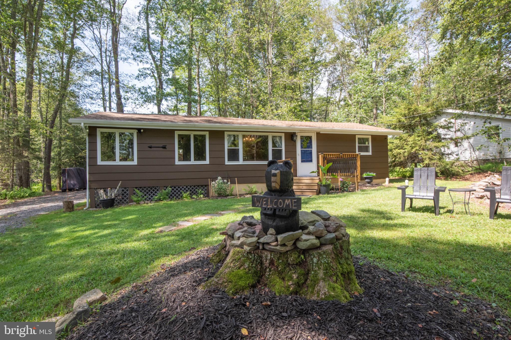Discover this charming 2-bedroom, 1-bath LAKE VIEW retreat nestled in the desirable Arrowhead Lake community. With warm white pine walls and ceilings, this cozy home captures the true spirit of a Pocono mountain escape.
The open-concept living and dining area is bathed in natural light, and the dining room window provides a tranquil view of the lake—ideal for sipping your morning coffee or enjoying dinner at sunset. A propane fireplace brings extra warmth and ambiance on cooler evenings.
This inviting home features a functional kitchen, two relaxing bedrooms, and a peaceful outdoor setting perfect for unwinding.
Location is everything—and this home is just a short walk (less than 2 blocks) to Beach 2, the boat launch, playground, kayak racks, and basketball courts.
As part of the Arrowhead Lake community, you'll have access to lakes, beaches, pools, a fitness center, clubhouse, and year-round activities—everything you need for fun, relaxation, and adventure in the Poconos.