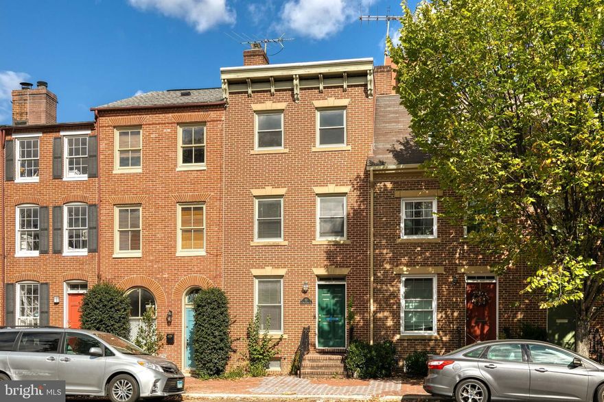 MAJOR PRICE IMPROVEMENT! Such an incredible opportunity to live in the heart of the historic Federal Hill district, WITH PARKING, just steps from Cross Street Market.  This home has been freshly painted a neutral grey tone, the carpeting has been replaced, and the hardwood floors refinished.  This is MOVE IN READY!  The living room is open to the dining room for an easy flow floorplan.  The kitchen has plenty of cabinet and counter space, plus room for a breakfast table.  There is a renovated powder room on the main level as well.  One flight up takes you to 2 oversized bedrooms, one with a private balcony and they share a renovated bathroom.  The next level up has an additional 2 huge bedrooms that also share a renovated bathroom. Turn the fully finished basement into the perfect rec room to watch the next big game, or it could even be a fantastic home office space!