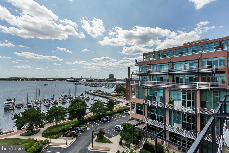 Spectacular waterfront condo in Canton Cove. 3 BR, 2 1/2 BA with walls of glass and 56 foot deck overlooking the Harbor. Finest finishes and amenities abound, custom Gourmet KIT, formal Living & Dining rms. Master Suite with 'lux Bath, walk-ins & built-in cabinetry. Library/Den with custom built-ins. 2 Additional Bedrooms & Bath. Travertine floors, custom lighting, laundry room, parking & storage.
