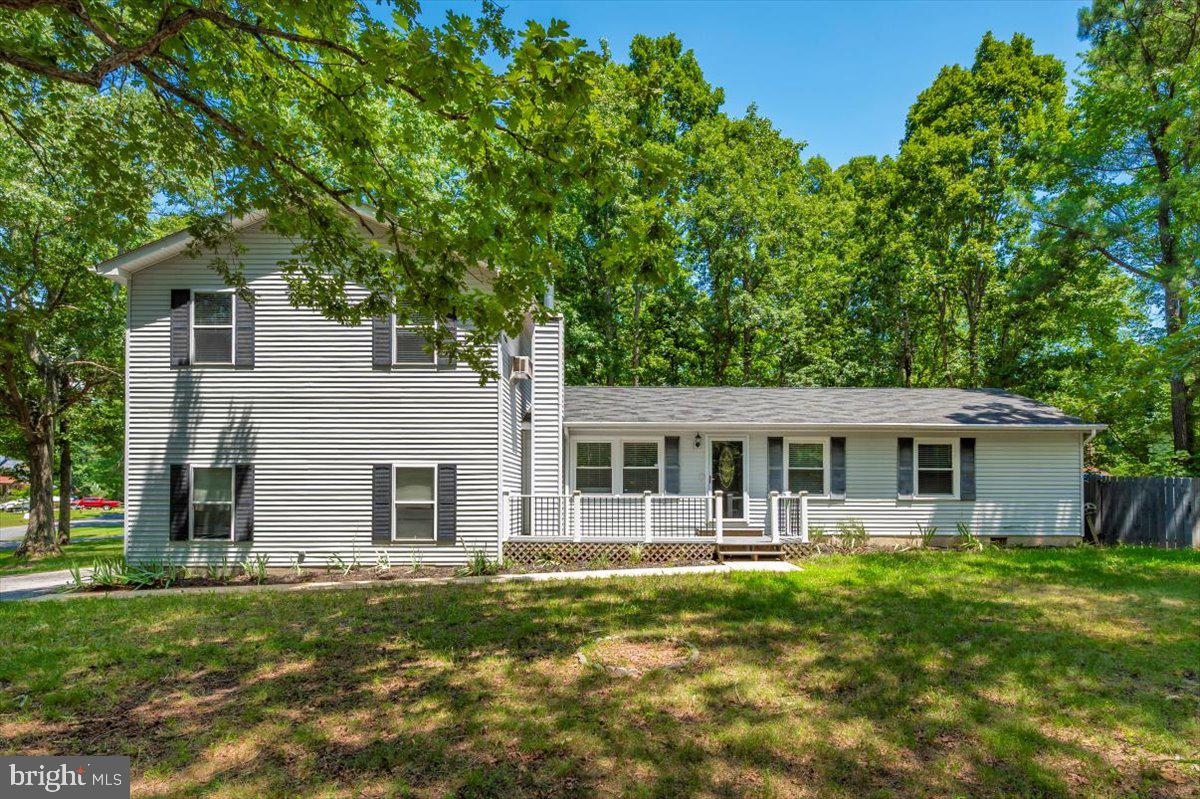 Welcome to 12284 Bandera Lane, a beautifully and completely renovated 5-bedroom, 3-bathroom home nestled in a tranquil, water-access community in Lusby, Maryland. Thoughtfully updated from top to bottom, this spacious home offers modern finishes, versatile living spaces, and exceptional outdoor amenities—perfect for families, nature lovers, or anyone seeking a peaceful retreat with access to the Chesapeake Bay lifestyle. Inside, you’ll find brand-new flooring throughout, updated light fixtures, fresh paint, and an inviting open-concept layout that effortlessly blends functionality and style. The heart of the home is the updated kitchen featuring brand-new stainless steel appliances, ample cabinet space, and an adjacent dining area ideal for hosting. The living areas are bright and airy, providing the perfect setting for everyday living or entertaining. All three full bathrooms have been fully renovated with contemporary fixtures and finishes, offering a clean, spa-like feel. With five generously sized bedrooms, including a main-level suite with flexible use, there’s plenty of space for everyone. Additional features include a brand-new washer and dryer, a spacious two-car garage for vehicles and storage, and a detached storage shed offering even more room for tools, hobbies, or seasonal items. Step outside to enjoy the large, fenced-in backyard—a private oasis perfect for kids, pets, and outdoor gatherings. The home sits on a quiet lot surrounded by mature trees, adding a sense of seclusion and tranquility. Located in a desirable water-oriented community, residents enjoy exclusive access to neighborhood amenities such as beaches, boat ramps, canoe and kayak launches, fishing areas, and designated swimming spots. Whether you’re paddling out for a peaceful morning on the water, casting a line in the afternoon sun, or enjoying an evening swim, this location offers a lifestyle few properties can match. Move-in ready and meticulously renovated, your new home combines space, style, and serenity in one of Southern Maryland’s most charming communities. This is more than a home—it’s a lifestyle.