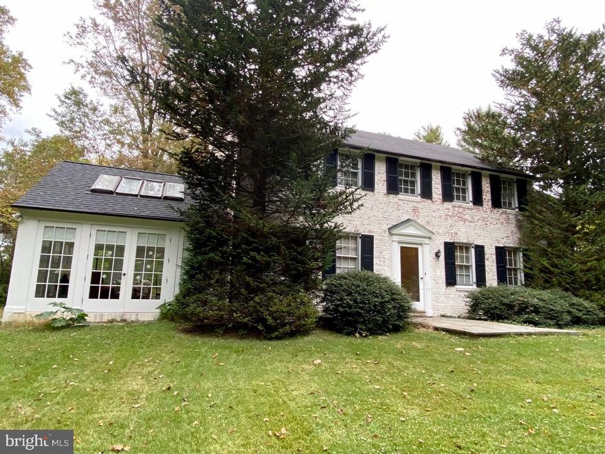 Charming, Vintage 2-story whitewashed brick colonial home in Westtown Township nestled on 2.8 acres of private, serene land, offering both space and tranquility.  This property is  on a quiet street within walking distance to the Westtown School. The home has original hardwood floors throughout, adding warmth and character.  There is a powder room and laundry room on the first floor.  A large formal living room with a  Fireplace , perfect for cozy evenings. There is a 4 season Sunroom off the Living room that was added in the 1990's with clay tile floor and glass windows on 3 sides that over look the beautiful property and its mature landscaping with special plantings throughout.  French doors connect the Sunroom to the Living room, enhancing the charm. There are 4 generously sized bedrooms and 2 full baths on the 2nd floor.  The built-in bookcase on the 2nd floor hall adds practical elegance.  Full, unfinished waterproofed basement & 2 car garage with Kitchen entry for convenience. There is a portion of the yard outside the back door that is fenced perfect if you have a pet!  New Roof within the last few years. Public Water is accessible. Possible subdivision to spin off a flag lot. Buyer to do due diligence.