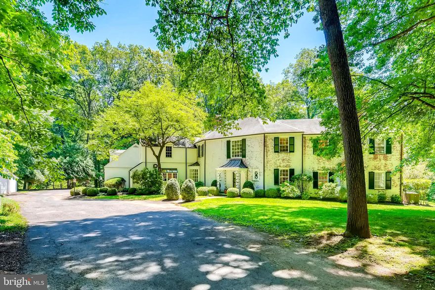 Elegant light-filled colonial situated on nearly eight private acres backs to lush woodlands in conservation with extraordinary views.  Beautiful estate property with fine finishes and stylish contemporary elements offers views from every window and features a handsome library and stunning formal living and dining rooms with high ceilings, hardwood floors, and wood burning fireplaces - all connecting through French doors to gracious covered rear bluestone terrace - perfect for alfresco dining. Impressive conservatory with towering ceiling adjacent to great room with fireplace is wide-open to a grand kitchen with luxe appliances capturing a boho-vibe style with sunshine yellow Vulcan 6-burner gas range and casual elements such as open shelving, large island, and impressive butcher-block counters. Main level also features two half-baths, laundry and mud room, butler’s pantry, home office, and retro phone booth. Second level offers large primary bedroom suite wing opening to remarkable balcony with majestic vista, four additional bedrooms and adjacent baths, unique art or yoga studio with wet bar and wall of built ins. Partially finished basement features rooms for recreation and fitness, and a multitude of storage space. Attached two-car garage and separate detached garage. Impressive, landscaped grounds include border gardens, specimen trees and shrubs, mature boxwood hedges, stone sitting walls bordering native gardens, and a touch-stone staircase leading to magnificent south-facing level lawn. A picturesque setting in a renowned scenic valley neighborhood. Just minutes to schools, shopping, I-695, and the best of metro Baltimore and the vibrant Inner Harbor.