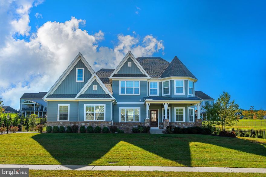 Tucked within the esteemed Ventry Community at Edgemont Preserve, 108 Parkview Way presents a tranquil retreat embraced by the beauty of its natural surroundings. This custom-built Nottingham model, only three years old, offers an understated elegance from the moment you arrive. A welcoming front porch introduces a home thoughtfully designed for both comfort and refined living.
Upon entry, the foyer gracefully opens into a spacious dining room with a charming bay window on one side and a private office with glass pocket doors on the other. The expansive living room, anchored by a gas fireplace, flows seamlessly into a gourmet kitchen. Designed for both culinary creativity and casual gatherings, the kitchen features double ovens, a butler’s pantry, and another bay window in the breakfast nook, adding to its airy appeal. A sunroom leads out to an expansive Timbertech deck, while the patio—complete with a built-in fire pit—provides an ideal spot to unwind, surrounded by lush landscaping and serene views.
The primary suite, located on the main floor, offers both seclusion and convenience. Two walk-in closets lead to a luxurious master bath, where a freestanding soaking tub, a spacious shower with dual heads, and twin vanities create a spa-like atmosphere. The laundry room, discreetly positioned near the garage entrance, offers easy access from both the primary suite and the rest of the home.
Upstairs, a large loft serves as a versatile space, flanked by three additional bedrooms, each with generous walk-in closets. The hall bath, equipped with double sinks and ample storage, serves the upper floor, while a bay window highlights the front-facing bedroom.