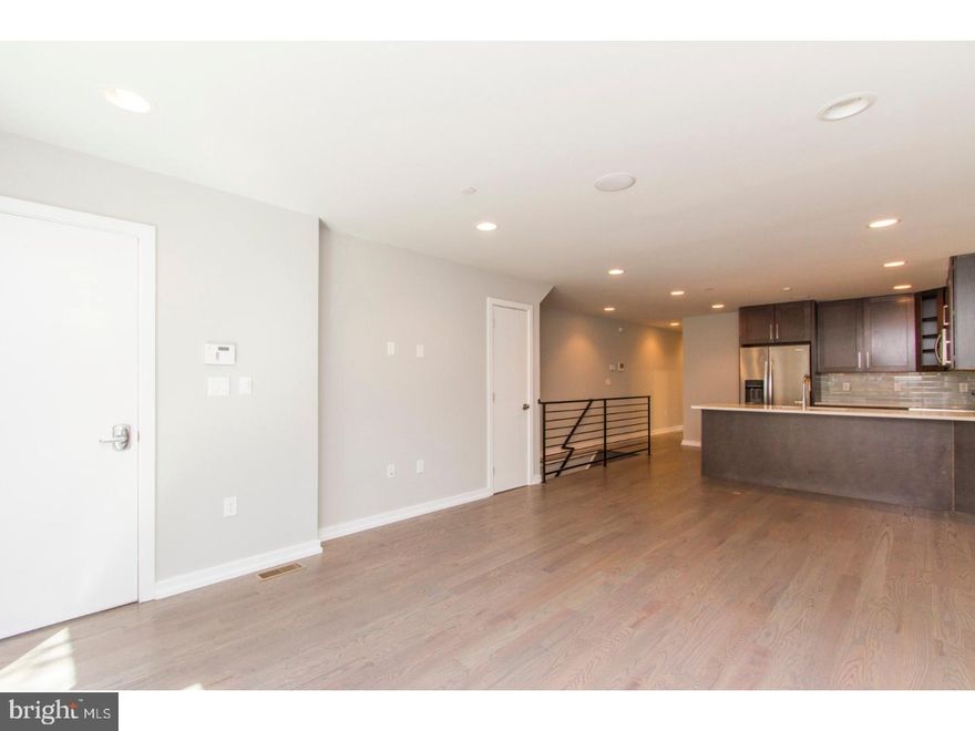 A gorgeous, new construction unit that's ready and waiting to be called home! Enter this bi level unit and discover the hardwood flooring, recessed lighting, high ceilings with installed speakers, and large energy efficient windows which provide ample natural light. The spacious, open living and dining space offers plenty of room for entertaining friends and family, and showcases the gorgeous kitchen, which includes granite counters and large island, stainless steel appliances, and a beautifully tiled backsplash. Continue past the kitchen to find the beautifully tiled bathroom with tub and shower combo, and separate stall shower with frameless glass enclosure, both with dual showerheads. The floor also includes a sun drenched bedroom with a walk in closet and access to a patio- just the spot for lounging on those sunny days! Downstairs features two lovely ensuite bedrooms with custom tiled bathrooms and stall showers with frameless glass enclosures. Washer and dryer are included in the unit, as well as an installed security system, and the location can't be beat- close to shops, restaurants, not to mention just minutes away from Center City. Don't wait, see this unit today!