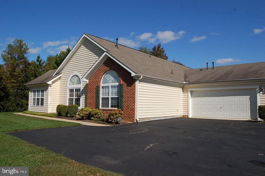 Don’t miss this spacious one-level villa in Regency Park Villas—one of the largest units in the community! This beautifully maintained home offers 2 bedrooms, a dedicated office, and a bright sunroom, providing flexible space for work, relaxation, or entertaining. The updated kitchen features quartz countertops and large cabinetry, with a convenient laundry room leading directly to the oversized two-car garage with additional storage above.  Both bathrooms have been recently updated with luxury finishes, including quartz vanity tops, tile flooring and shower surrounds, and designer fixtures.  The open living and dining area with a cozy corner fireplace creates a warm, inviting space, while French doors lead to a sunroom filled with natural light for year-round enjoyment. Situated at the rear of the community, this unit offers added privacy and peaceful views.  Enjoy low-maintenance living—the condo association handles most exterior upkeep. Not age restricted and conveniently located near shopping, medical facilities, commuter lots, and I-95 for easy access to Richmond and DC.