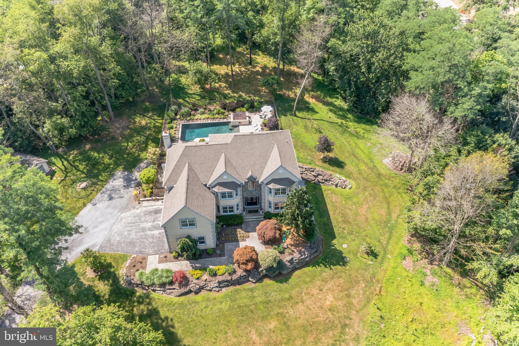 A Secluded Hilltop Estate Minutes from West Chester — Timeless Elegance Meets Modern Resort Living
Perched atop nearly 6 acres of rolling, tree-lined hillside, 1303 Lenape Road is part of Pas de Deux — an exclusive enclave of just two executive residences on a private lane just south of West Chester.— blending refined luxury, impeccable design, and effortless proximity to the cultural heart of West Chester.
Bathed in natural light and impeccably maintained, this 5-bedroom, 4.5-bathroom residence spans expansive interior spaces thoughtfully designed for both grand entertaining and intimate daily living. From the moment you enter the soaring foyer, you're met with an immediate sense of calm, sophistication, and craftsmanship.
Main Level Living: Designed for Entertaining & Everyday Luxury
At the heart of the home, the chef’s kitchen features top-tier Thermador and Kitchen Aid appliances, sleek surfaces, and a fluid layout that opens to formal and informal gathering spaces. French Doors transition seamlessly to the outdoor living area — perfect for evening cocktails or weekend brunch by the pool. Rich hardwood floors, oversized windows, and architectural ceilings frame views of the lush grounds and curated gardens.
Step down to the vaulted great room, where a dramatic wall of glass overlooks the resort-inspired pool and patio — a stunning backdrop for hosting or simply unwinding in style.
A Primary Suite Retreat
Upstairs, the spacious primary suite offers a sanctuary-like experience with its own sitting room, spa-inspired bath, custom walk-in closet, and a beautiful stone-accent feature wall. Each of the additional bedrooms is generously proportioned, with character-rich details and semi-private bath access.
Lower Level: Luxury Beyond Expectations
The finished walk-out lower level boasts soaring 9.5’ ceilings and elegant, bespoke finishes — including handcrafted doors, a second full bar, billiards lounge, steam shower, and ample space for fitness, media, hobbies, or multi-generational living. Every inch reflects quality and thoughtful design — even the utility/storage areas are immaculately organized. A whole-home Generac generator ensures continuous comfort and peace of mind.
Outdoor Oasis: Resort-Style Living Year-Round
Step outside into a private, fully landscaped paradise: a state-of-the-art heated pool, hot tub, and multiple lounging and dining areas set against a serene, wooded backdrop. Automated awnings and pool controls bring ease to al fresco entertaining. Thoughtful garden placements — from blooming florals to herb clusters — elevate both the beauty and functionality of the grounds.
Location: The Best of Both Worlds
While this property offers true seclusion and tranquility, it’s just minutes from the boutiques, restaurants, and historic charm of downtown West Chester. Enjoy quick access to Radley Run Golf & Country Club, Longwood Gardens, King of Prussia, and Philadelphia — placing world-class dining, recreation, and travel within easy reach.
________________________________________
This is more than a home — it’s a lifestyle estate.
For those who value privacy, elegance, and effortless luxury, 1303 Lenape Road is a one-of-a-kind opportunity. Schedule your private tour today.
