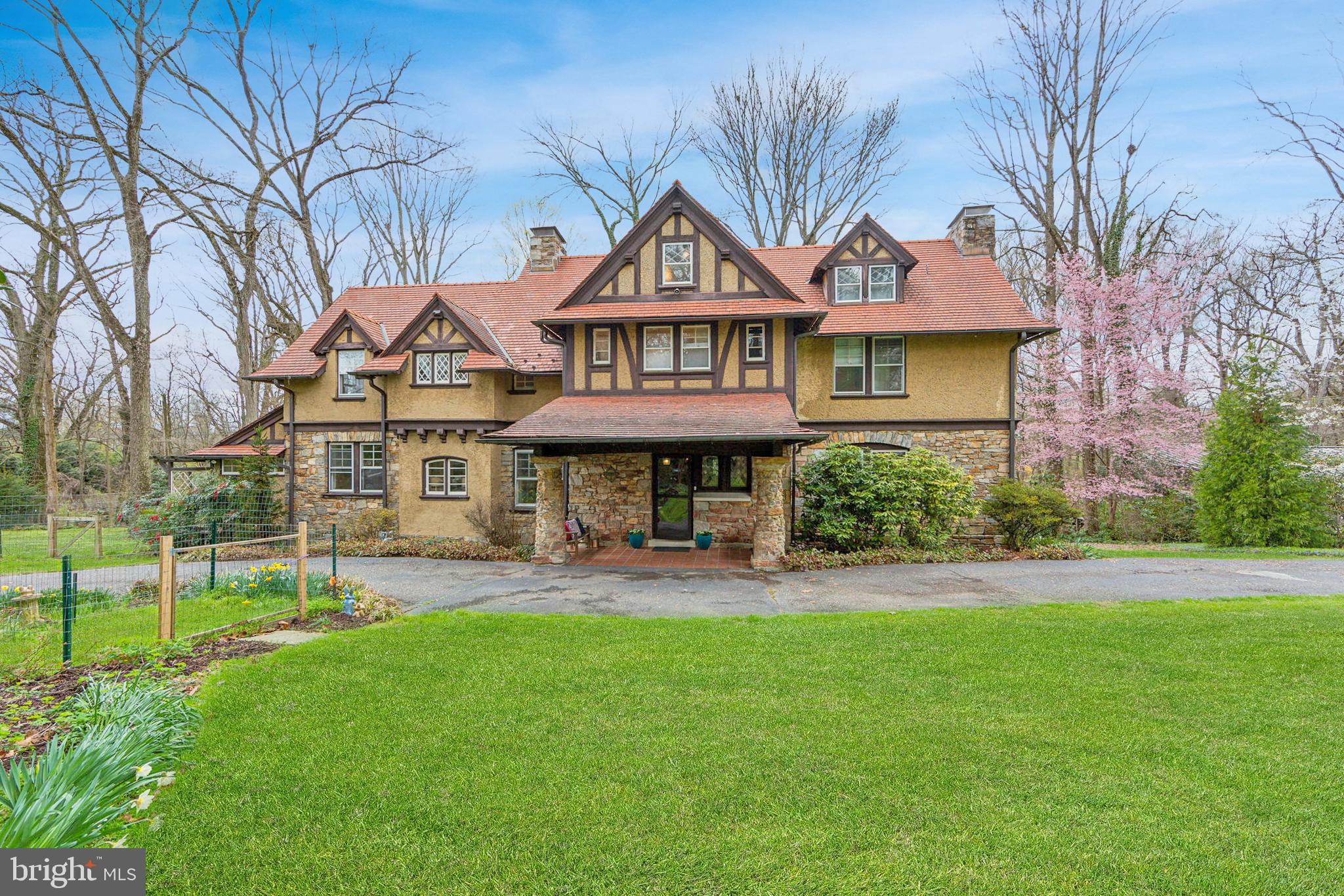 Welcome to 222 Moylan Avenue, a rare and beautiful Arts and Crafts home built by Walter F. Price in 1910 for Franklin N. Brewer, the General Manager at Wanamakers in Philadelphia. This 5-bedroom, 3.1-bathroom home, which was named "The Trees" in honor of its lush and tranquil setting, sits on a large, approximately 1.5-acre lot that includes an outbuilding/detached garage and a circular driveway. It feels tucked away, yet is close to Media borough, Wallingford-Swarthmore schools, and the lovely surrounding neighborhood. 222 Moylan features an original (but recently and thoroughly refreshed) ceramic tile roof, four fireplaces, soaring beamed ceilings, wood flooring, and gracious rooms, as well as newer kitchen and bathroom updates. Exquisite details abound including unique windows, gorgeous trim and woodwork, and built-in cabinets. Pull into the driveway and enter the home to the foyer with a stunning staircase and built-in bench. Take in the beauty of the vast living room, featuring a dramatic stone floor-to-ceiling fireplace and massive ceiling beams. There is a Dutch door to the charming porch that runs along the backside of the home – the perfect place to unwind or socialize with family and friends. Next is the generous, light-filled dining room with built-in cabinets. Follow along to the butler's pantry, filled with custom cabinetry, that leads to the gorgeous new kitchen with white cabinets, stainless appliances, and quartz counters. There is a back staircase for convenience, and a door to the backyard. From the kitchen discover a spacious laundry room with lots of shelving and nooks for storage, and a door leading to the side yard. A charming half bath and coat closet complete this floor. Upstairs discover the primary bedroom with a fireplace, custom shelving, and an adjoining dressing/reading room. Down the hall is a 2nd family/living room with a fireplace that could serve as another bedroom. There are 2 updated, sizable full bathrooms – 1 with a tub-shower combination and the other with a shower. A large hall walk-in linen closet, office nook, and 2 additional bedrooms complete this floor. The 3rd floor has been beautifully finished to include 2 sizable bedrooms with a large closet and lots of storage space, as well as another full bathroom with a soaking tub. The unfinished basement with egress is very large; it houses the utilities and has plenty of storage space. Finally, the grounds of this property are quite lovely, and they offer endless potential for future gardens, children’s play areas, a fire pit, and even a pool. There is an original outbuilding (once a stable) that is currently used for storage but could fit one car. Next to it is a large, conditioned (mini split for heat/AC) room that is currently used as an exercise room. The location of this home is wonderful – very close to two train stations, downtown Media, major roadways, Philadelphia, and the airport. Historic images courtesy of The Athenaeum of Philadelphia.