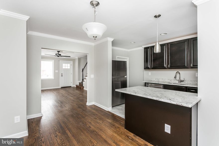 Stunning renovated property including 3BR, 2 Full BAs and finished basement with additional BR/Den. Original refinished hardwood floors bring life and character to the main and upper levels of the home. The main level contains an open concept space with LR (incl recessed lights and ceiling fan), DR, and brand new custom kitchen with soft-close cabinetry, new stainless steel appliances, and new granite countertops with breakfast bar. Basement has been completely refinished including new full bath with custom tile. New systems throughout, freshly painted, new hardware and doors - too much to list! House includes parking across the alley and fenced in rear yard. A true steal under $150k!