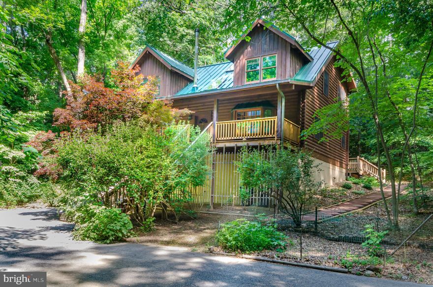Private and Pristine in a Parkland setting! This fabulous log home is priced less than its tax assessment but boasts upgrades galore including a generously sized front porch, metal roof (with a lifetime guarantee) and geothermal heating and cooling to ensure comfort year round! The owners have lavished love on this home spending over $150,000  in the last 1.5 year. Improvements include not only the 4 ton geothermal system and green vertical seam metal roof but also a  renovated master bath (heated tile floors, new vanity, frameless shower doors, new tile etc), new front windows, new half bath in basement, fresh paint and more! High ceilings on all three levels, skylights and open beams plus a sprinkler system. Propane gas tank to fuel gas cooking on burners! Huge two level deck (complete with built in benches) provides a wonderful location for entertaining a crowd al fresco. Enjoy the privacy of your own woodland preserve with 4 acres (about half of which is subject to a Maryland National Capital Parkland Planning Commission conservation easement). The current owners have thoroughly enjoyed the easy access to their own walking/riding trail in the woods! This farmette is a birdwatcher's haven where turkeys, owls, hawks, pileated woodpeckers and more are frequently seen or heard. Pick your own raspberries in May-June Trees include many Redbuds, Dogwoods, Crepe Myrtle, Japanese Maple and Holly. Other plantings include sweet smelling Viburnum, Camelia, Rhododendron and daffodils. A private Oasis sure to please the most discerning buyers.