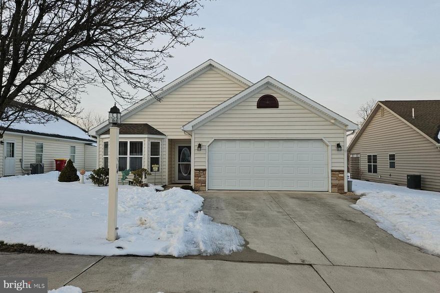 The one you have been waiting for!  This spacious and lovely single family home in Country Manor is well maintained and move in ready.  With 1705 finished square feet this home has more space than most and it's pleasant floorplan boasts 3 bedrooms, 2 full baths, an eat in kitchen with pretty cabinets and space above to show off your collection of...whatever!   There is a formal dining area that opens to the living room (this owner has removable screens creating an office space in the dining area)  The stone fireplace (gas) is so pleasing as is the large primary bedroom with big bathroom.  You will love the year round sunroom and rear deck overlooking the meadow. The garage is more than adequate to house 2 vehicles with extra space for storage or room to putz. The laundry room is big and spacious, too! This exceptional home is located in Shippensburg's premier 55+ community!  The HOA fee for Country Manor includes sewer and trash and access to a fantastic clubhouse featuring an elegant, open concept with a full kitchen, lounging area with fireplace and dining hall.  There are extensive wood bookshelves brimming with titles for hours of enjoyment.  A monthly calendar offers fun events like bingo.  Group trips are often planned, too!  There is a separate workout area available for a small additional monthly fee.  In the summer months the fishpond (catch and release) and gazebo are popular spots and there are outdoor games available such as bocce ball and corn hole!  Two dog parks, walking paths and benches complement the common space.
A lovely home in a vital, carefully planned gated 55+ community...Your future looks golden!