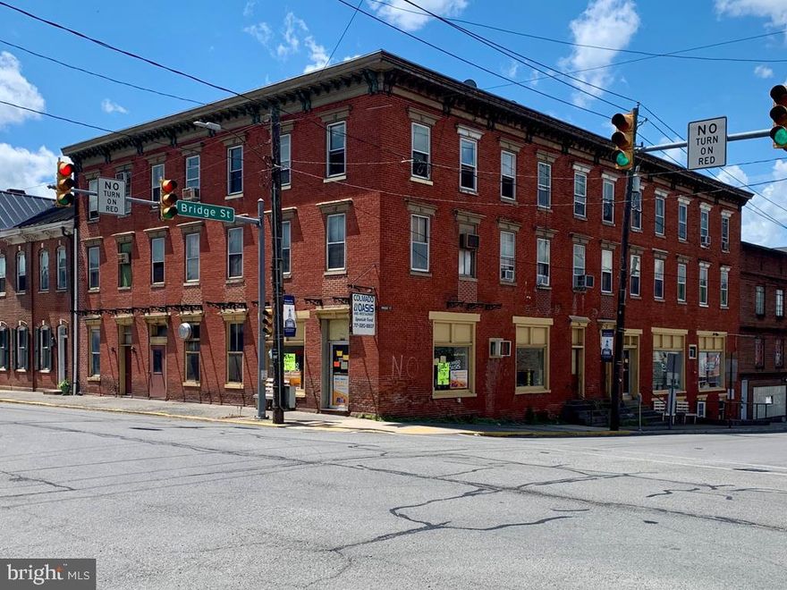 Large multi-unit, multi-purpose commercial building in the square of Mifflintown. 10 apartments and 1 retail space are all currently occupied and bringing in nice cash flow. There are (6) 2 bedroom units, (3) 1 bedroom units, (1) studio unit, and (1) retail space currently operating as a grocery store. The building also includes 2 coin operated washer/dryer combos. Great location for many of the tenants that walk to work at a nearby factory. Financials available for qualified investors.