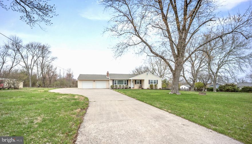 Absolutely Stunning remodeled ranch home on 1.26 Acres of beautiful open space! Look no further - this home has been renovated from top to bottom and leaves no stone unturned!  As you arrive, you will notice a long driveway leading to an expansive two car garage and covered front porch! Beautiful gleaming laminate floors await you as enter into the home.  The formal living room on your left immediately welcomes you with the warmth of a cozy brick fireplace and large windows with views to the exterior! The large granite island gives ample space for seating in this designer kitchen which features striking white cabinetry, modern tiled backsplash, stainless steel appliances, and a large farmers sink!  Recessed lighting also accents this space which opens to the dining room!  Adjacent to the dining room, sliders lead to an amazing all-season room with newly installed luxury vinyl plank floors and affording spectacular views of the rear yard and the gorgeous stone patio! Lots of rear space for entertainment on those warm summer days with barbecues and scenic views! Main level features three very nice size bedrooms, all having custom built-ins in the closets. Main bedroom has its own remodeled bath with vanity and shower. Second Full Bathroom on main level features porcelain tiled floor, newer vanity and tub and shower surround.  As you venture into the lower level, you will be mesmerized with a massive open floor layout! Great space for watching TV, added areas for home office, and lower level also features a separate spacious fitness room! Recessed lighting throughout makes this bright & airy and there is plenty of added space for storage and also a laundry room! This move in ready home features a newer Roof (2022), finished Basement (2021) and new hot water heater (2024).  If you are desiring lots of land and a gorgeous, remodeled home – this is definitely the place for you! Located in Council Rock School District, with easy access to all major throughways, & only a few minutes’ drive to Newtown Borough!