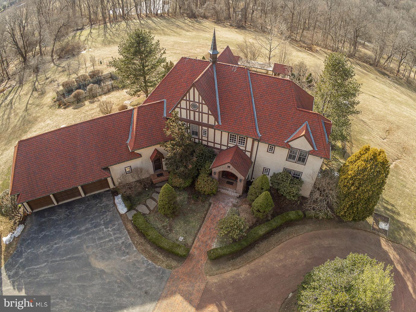 Welcome to "Belmeade". This Peter Batchelor custom built Country Manor Home with approx. 6,000 square feet of living space is located at the end of a very special cul de sac street with a long history! This 6 Bedroom, 5.5 Bath stately Home on the most private 15.2 acres awaits your visit. As you head up the long winding driveway to this Home it fills you with a sense of peace with gorgeous views from every angle. Enter the Foyer and feel right at home. On one side of the foyer you will find a Bedroom with en-suite Bath and on the other is the Dining Room with hardwood flooring. Hardwoods flow into the Great Room with an abundance of windows to show off the spectacular views. The spacious Library has built-in bookshelves and is a great place to work from home! The spacious and bright Eat in Kitchen with Breakfast Room has brand new hardwood flooring, 2 tier island, professional grade double stove/oven, 2 sinks, insta-hot water and a gas fireplace. Completing the Main Floor is the Powder Room, Laundry Room with dog wash area and Mud Room with access to the 3+ car HEATED Garage! Upstairs you will find the Main Bedroom with walk in closet and en-suite Bath, Princess Bedroom with en-suite Bath, 2 additional Bedrooms, full Hall Bath with jacuzzi tub, a Sitting Room PLUS another Bonus Room/6th Bedroom with access to the first attic area with electric and plumbing! Another level up is the 2nd attic, great for storage! The WALK OUT finished Lower level is simply amazing – with a huge Rec Room plumbed for a wet bar, large Gym with steam room, full Bath, wine room, large Pantry, utility room and exit out to the fenced in paver patio and inground Pool! Move outside and find the most private and tranquil setting. Sit on the Patio and relax, take a swim in the Pool, tend to the garden (fenced & trenched), pick fruit from your own Orchard (apples, pears and peaches), play horseshoes or just take in the scenery which is protected and can never be changed! A few more features to note on this wonderful home: whole house generator, 3 zone HVAC with I wave purification, CAT 5 wiring, 400 AMP service and so much more! Deed allows for one (1) 1,200 sq. ft. guest house PLUS barn or other nonresidential outbuildings. The community of Pine Creek consists of 24 home sites on 235 acres which are part of a 450+ acre deed restricted neighborhood of woods, ponds, streams, meadows and a horse trail. There are walking trails set aside in the neighborhood that connect to historic Horseshoe Trail, all perfectly located close to major highways, restaurants and shopping. Award winning Downingtown School District! A wonderful Home in a very special location! Take the Matterport tour at https://my.matterport.com/show/?m=KY67fTLV3Yq