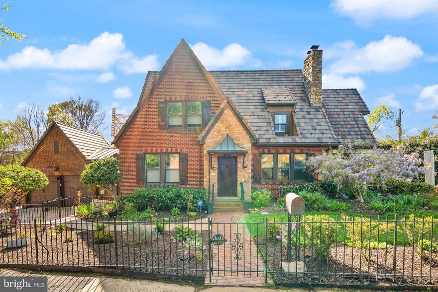 Rare gem in the heart of Lyon Village, a beautifully preserved 1928 Tudor with 4 bedrooms, 3 full bathrooms, and 2,459 finished square feet of timeless character and modern comfort. Set on a massive .23-acre lot just two blocks from the Clarendon Metro, this home offers the perfect blend of historic charm and unbeatable location. From the moment you arrive, you’ll be captivated by the Italian slate roof, elegant stone driveway, and iron-fenced yard with mature privacy plantings. Inside, original woodwork and a striking stone fireplace create a warm, inviting atmosphere, while the sun-drenched main level features a flexible bedroom or home office with a full bath, perfect for guests or remote work.The eat-in kitchen is outfitted with stainless steel appliances, granite countertops, and an oversized walk-in pantry that leads to a convenient mudroom and attached two-car garage. Upstairs, three additional bedrooms and two full bathrooms offer plenty of space to spread out. Outside, two separate patios provide idyllic spaces for lounging or entertaining under the stars. Additional highlights include a bright bonus sunroom, thoughtfully landscaped outdoor spaces, and the unbeatable walkability of Lyon Village, just moments from dining, shopping, parks, and transit. Storage includes a 949 sqft unfinished basement and walk-up attic. This is a truly special home in one of Arlington’s most coveted neighborhoods. Don’t miss the opportunity to make it yours.