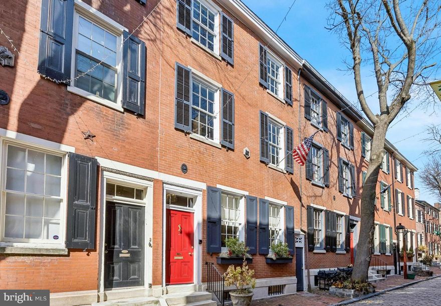 Welcome to 318 S. American Street, a beautifully-appointed residence tucked along one of the most charming blocks in Philadelphia’s historic Society Hill neighborhood. Combining timeless character with thoughtful modern upgrades, this exceptional home also offers rare and highly coveted features for city living— three outdoor living spaces AND a deeded 1-car parking space (#18) in the secure, gated lot directly behind the home!

Enter through the welcoming vestibule into a bright and elegant living room featuring random-width original hardwood floors, high ceilings with dramatic crown molding, large windows with Roman blinds, and beautiful designer lighting that enhances the home’s classic architectural details. The living room flows seamlessly into the dining area, where two glass-fronted built-ins provide both character and functionality. Natural light pours in from the lovely middle flagstone patio, creating a warm and inviting space ideal for both everyday living and entertaining.

The fully renovated kitchen (2024) is a true standout, designed with both style and performance in mind. This space is truly a sanctuary with vaulted ceilings and natural light coming in from both patios, accented by the slate roofline above. A striking herringbone tile floor compliments the custom tiled backsplash, the sleek quartz countertops and the custom shaker-style cabinetry, while premium appliances include a Fisher & Paykel induction 36" range, Liebherr refrigerator, and Miele dishwasher. The kitchen opens directly to the private rear brick patio, offering easy indoor-outdoor living and convenient access to the deeded parking space. A well-placed and stylish powder room completes the main level.

 Downstairs, the finished basement provides an inviting family room featuring hardwood floors and a cozy gas fireplace—perfect for relaxing or hosting guests. This level also includes an additional powder room, a wine refrigerator, and a dedicated laundry area with full-sized washer and dryer.

The second level offers a quiet and functional private office highlighted by built-in shelving and a distinctive oval-shaped window. Just beyond is the spectacular primary suite, featuring hardwood floors, high-ceilings, a ceiling fan, and two spacious double closets. The luxurious primary bathroom showcases custom tilework, a soaking tub, double vanity, and a spa-like shower with frameless glass enclosure.

Continuing upward, you’ll find access to another outdoor retreat—a sunny rear deck which is ideal for your morning coffee or evening relaxation. The upper level of the home features two additional bedrooms, each with a ceiling fan, ample closet space, and window blinds, connected by a Jack-and-Jill bathroom with a shower/tub combination and space-saving pocket doors.

Additional highlights include: an EV charger for the parking space, two HVAC systems, a tankless high-efficiency water heater, a water softener, newer windows, and custom window treatments throughout.

318 S. American Street is a must-see gem offering maximum comfort, style, and convenience on one of Philadelphia's most sought-after streets!