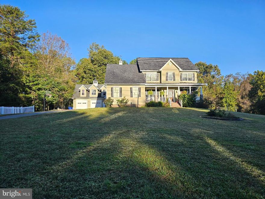 Welcome to this beautiful, custom-built Craftsman Colonial style home. The original homeowners have taken great pride in this home and have added many upgrades. 
There is an adorable Cape Cod style detached two story, two car garage with oversized bays that boasts a one bedroom/one bath apartment on the upper level.  The apartment has a well-appointed kitchen with a farmhouse sink that is situated beneath the kitchen window to provide a view of the property. The laundry room is located downstairs. There is a private entrance with a new entry door and a stairway that leads to the upper-level apartment. The apartment is on its own separate septic and electric meter. There is no HOA. This space would be ideal for multi-generational living, guests, as a rental or as a private retreat.
The main house has a beautiful front porch with brick columns and a lovely entry door. There are mature flowering bushes such as hydrangeas, butterfly bush, lilac, rhododendrons and berry bushes along with other flowering perennials. The property would be perfect for homesteading, mini-farming, gardening or just relaxing and enjoying the privacy.  Welchs Acres Pl is a private drive with only two other properties. Located 3 miles from and facing the Patuxent river allows for taking in the most amazing sunrises from the front porch swing.  The side load garage has access to a large mud room/laundry room with washer and dryer, built in cabinets and a stationary tub. Adjacent to the laundry room is a huge walk-in pantry with wrap-around shelving. There is also a full bath. The gourmet eat-in kitchen has custom Amish built Hickory kitchen cabinets, Absolute Black granite countertops, brand new (never been used) Samsung stove and Samsung Bespoke refrigerator. There is a large granite top kitchen island with pendant lighting making this the perfect space for food preparation or entertaining. Just steps away from the kitchen is the 14 x 35ft low maintenance Trex deck perfect for outdoor gatherings or peaceful relaxation. Adjacent to the kitchen is the spacious family room with a cozy propane fireplace. There are freshly finished wide plank, heart pine floors throughout the main level. The upper level has four bedrooms and four baths. The owner's suite has an impressive tray ceiling, ensuite bath with pocket doors, a soaking tub with jets, a large walk-in shower with double shower heads and a double vanity with custom Amish built cabinets and a spacious walk-in closet with shelving. There are three secondary bedrooms. One of the secondary bedrooms has an ensuite bath and a walk-in closet. The other two secondary bedrooms share a Jack and Jill bath and both have ample closet space. 
There is custom trim throughout the home. New wall-to-wall carpet and fresh paint throughout. Whole house water filter with water softener. New exterior doors for basement and kitchen. Walkout basement with 12 foot ceilings and full-sized windows to let in plenty of light. The basement has a full bath rough in. The home has a newer roof - replaced in October 2020. A newer 10 x 16ft pool shed with painted interior and potential to be finished into a she-shed or poolside hangout.  Fully fenced backyard with above ground pool. There is so much to see and appreciate at 6935 Welchs Acres! Schedule your showing today! Professional photos will be uploaded soon.