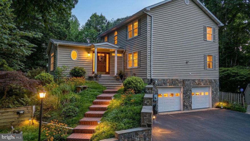 Tucked quietly into Owings Hills, this home feels like it was pulled from the pages of a storybook.
Follow the brick steps to the front door, and you’ll pass through perennial gardens that bloom and change with the seasons. Stone walls frame the landscape. Winding paths lead you to hidden corners. There’s even a fire pit tucked into the woods, reached by its own set of brick steps, ready for late nights under the stars.
Out back, a beautifully designed upper deck invites you to sit, stay awhile, and take in the view. Built-in benches, layered decking, and thoughtful details make it feel less like a backyard and more like a private retreat. A generator will convey, offering peace of mind year-round. The outdoor sprinkler system keeps the lush landscaping and gardens looking their best with minimal effort. And with no HOA, you have the freedom to enjoy your property without added restrictions, all while still being part of a well-established and desirable community.
Inside, the home balances charm with modern updates. The kitchen has been carefully remodeled with custom cabinetry, hign-end appliances, granite counters, and a pantry that keeps everything in its place. The primary suite offers a quiet escape with a generous walk-in closet, while the lower level includes a workshop space for creating, building, or simply getting away for a bit.
The home also offers exceptional flexibility for today’s lifestyle. A main-level bedroom and full bath provide the perfect setup for extended family, guests, or multi-generational living without compromise. Just off the main living areas, a spacious office with custom lighted built-ins creates a polished and inspiring workspace, ideal for working from home or managing day-to-day life with ease.
Everywhere you look, there’s intention. New architectural shingles overhead. Stone and bluestone accent the grounds of the property. Fenced garden spaces ready for planting, growing, and enjoying.
And then there’s the lifestyle.
Just minutes away, North Beach and Chesapeake Beach offer a completely different pace. Morning walks along the boardwalk. Coffee by the water. Fresh seafood, marinas, boutique shops, and summer concerts by the bay. It’s the kind of place where weekends feel like a getaway without ever leaving home.
When it’s time to head out, you’re still within reach of everything: DC, JBA, and Annapolis. Properties like this rarely come to market. The combination of privacy, curated outdoor living, thoughtful upgrades, and proximity to the Bay creates a unique opportunity that is difficult to replicate.