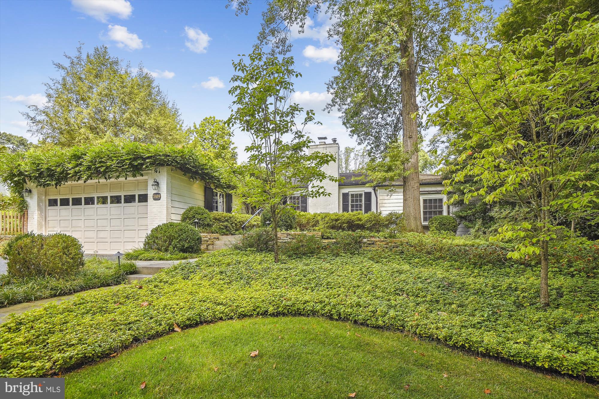 Don’t be fooled by a quick drive by - this home is beyond spectacular. Nestled in the middle of Ruxton’s finest streets, 7809 Overbrook is enchanting. Custom details and modern updates meld with traditional features – coming together in a sprawling flow of space and the most glorious yard and gardens. A traditional foyer welcomes you – an intimate space that connects all dimensions of the home. The large kitchen with center island is a chef’s dream and is awash in natural light. It opens to the most welcoming family room with custom built-in cabinets, fireplace and a bank of windows and doors to the back yard. Entertain your most distinguished guests in the sophisticated dining room or gather in the elegant living room that offers another lovely fireplace, a refined correspondence nook and French doors that open to a magnificent awning-covered patio. The bedroom space was thoughtfully designed on one side of the home - separating entertaining from respite. The front bedroom has a private ,updated bathroom. Two additional bedrooms share an updated hall bathroom. Capping the end of the wing is a serene primary bedroom with French doors that open to a patio and a picture window overlooking magnificent gardens. The traditional elements of this home - arched doorways, stately moldings and gleaming hardwood floors - are accompanied by today’s must-have conveniences: an entertaining bar, first floor laundry room and an attached garage that connects to the home via a charming covered porch. The finished lower level has a little bit of something for everyone: ample storage space, a large recreation room with custom built-ins, and a bonus room for your favorite hobby. The allure doesn’t stop inside - prepare yourself for one of Ruxton’s best yards. Just shy of an acre, it is wonderfully designed with gardens that mesmerize. The front idyllic garden feels like an English retreat. The back yard nourishes all your senses. Take in the beauty of the sweeping yard, the smell of the abundant flowers and the feel of the refreshing pool (salt!) water on your skin. The landscaping was curated with the most astute eye to detail. Every garden club petitions for a field trip to this home. This well-loved and cared-for home is an exceptional residence. It is a rare and captivating find.