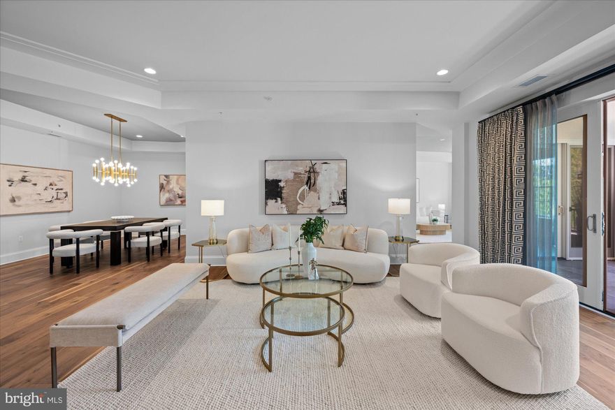 Presenting the pinnacle of luxurious living: the former Builder's model at the exclusive Quarry Springs. Positioned in a serene enclave at the rear of this resort-style community, the residence is enveloped by meticulously landscaped gardens, a cascading waterfall, a picturesque gazebo, and a pristine pool. "The Montrose" floor plan offers an expansive 2,700 square feet of unparalleled interior living space, complemented by an additional 440 square feet of private, covered terraces that boast sweeping courtyard and pool vistas.
Arrival is a grand experience, with a private elevator opening directly into a magnificent foyer. The eye is immediately drawn to the premium 7-inch EcoTimber hardwood plank flooring and substantial 10-inch base moldings that anchor the space. Bespoke details abound, including lavish designer lighting fixtures, custom illuminated cabinetry, and a stately mantled gas fireplace. Elegant tray ceilings with recessed lighting further accentuate the impressive vertical volume throughout the home. From the adjoining formal living and family rooms, seamless access is granted to the first of two expansive covered terraces.
Offering two generously proportioned bedrooms, two and a half luxuriously appointed bathrooms adorned with custom designer wallcoverings, and a versatile family room, this residence represents the very quintessence of elegance. It is situated within a highly secure, gated Bethesda community, where residents enjoy the utmost privacy and exceptional service, including a dedicated gatekeeper, personal concierge, and doorman. Exclusivity is guaranteed, as Building Four is an intimate enclave comprising merely 24 units.
The culinary center is a masterpiece of both form and function. A true chef's kitchen, it features sleek, designer white Woodmont-style cabinetry by the Suss Group, beautifully contrasted by exquisite marble countertops. The suite of professional-grade appliances leaves nothing to be desired: a 42-inch Sub-Zero refrigerator, a 30-inch five-burner Wolf gas cooktop with an exterior-venting range hood, a 30-inch Wolf convection oven, a 24-inch Wolf convection microwave, and a discrete Sub-Zero under-counter wine and beverage preservation center. The space is flawlessly completed by a Bosch dishwasher, a stainless steel Waterworks faucet, and a Blanco under-mount sink.
The primary owner's suite is a private sanctuary, offering direct access to the second covered terrace and featuring expansive, custom-built closets. The accompanying en-suite bathroom is a spa-like retreat, boasting an oversized walk-in shower, a freestanding Waterworks soaking tub, and a dual-sink vanity swathed in pristine Carrara marble, all complemented by premium Waterworks and Toto fixtures. The secondary bedroom is equally inviting, featuring exquisite designer wallcoverings, access to the terrace, and a private en-suite flawlessly finished with high-end Waterworks and Toto accessories.
Practicality meets elegance in the dedicated laundry room, outfitted with pristine white cabinetry and an oversized washer and dryer. This space conveniently connects to a private rear service entrance, ideal for discreet personal deliveries. Adding to the effortless living experience, Unit 423 conveys two assigned parking spaces and a dedicated storage unit within the immaculate, secure underground parking garage.
Residents of Quarry Springs at Stoneyhurst are afforded an unparalleled lifestyle with comprehensive amenities, meticulous custodial maintenance, high-speed internet, on-site management, and snow removal. The community features a state-of-the-art health club, beautifully manicured gardens, and expansive recreation and club facilities. Superbly located just blocks from major thoroughfares, with effortless access to Washington D.C., N.Virginia, and three international airports. Furthermore, enthusiasts will appreciate being less than 3 miles from the prestigious Congressional, Burning Tree,  Avenel & Bethesda Country Clubs
