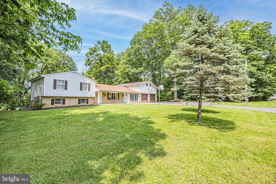 SELLER OFFERING A CREDIT TOWARDS A ROOF!!!Well-maintained tri-level home available in Chesley Estates, a serene and quiet subdivision of Falling Waters!!  Large family room as soon as you enter with luxury flooring and a large picturesque window letting in an abundance of natural light. Just off the family room, you'll find the sunroom with hardwood floors, a walk-out to the flat, fenced-in backyard with a large array of mature trees, and the entrance to the four-car garage with a large storage space overtop  running the entire width of the house. The family room opens up into the eat-in kitchen with a walk-out to the back deck, tiled floors, stainless steel appliances, and custom wood cabinets. Lower level walk-out with a rec-room with luxury vinyl flooring and an elegant woodstove, a bedroom, and a laundry room. Upper-level master bedroom with a perfect view of the backyard, a large closet, and an en-suite bathroom with tiled floors and a shower stall.Two more generously sized bedrooms on the upper level with ample closet space both sharing a full modern hallway bathroom. If you enjoy peace, quiet, and roaming wildlife, you have come to the right place!!