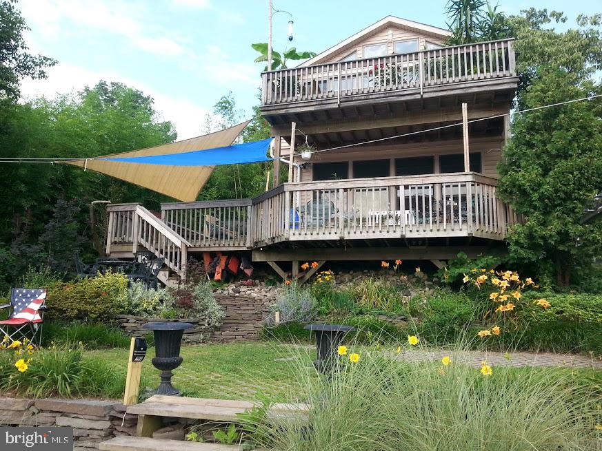 Riverfront New Hope Borough - one of the last opportunities to own a piece of paradise. One of the few riverfront properties available, this home, once the studio of a local potter, has multiple uses...currently three residences,, this unique property could be converted back to two residential units, or a single family home, or add a business. With parking for 6+ cars, large decks, terraced to the river, it is a wonderful property for entertaining, or for a weekend getaway, and it produces income to pay for the weekend retreat. The configurations are many and limited only by your imagination and needs. If you are a river enthusiast, this is the spot with views of the wing dam and the New Hope Lambertville bridge. Walk across the street to access the canal path or out the back door to jump into your boat to enjoy fishing, cruising or rowing. Not to mention you can walk down the street to all of the wonderful restaurants and entertainment without having to find or pay for a parking space. Owner is licensed PA and NJ realtor.