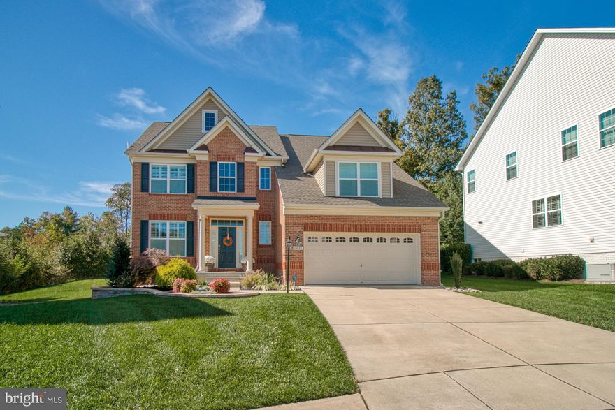 Beautifully landscaped immaculate  single family brick front home in the Highland Meadows neighborhood , Gambrills, MD. Located on a cul-de-sac be sure to step out onto the rear deck and lovely backyard to enjoy the view overlooking a nature preserve treed and wooded area. Built in 2014 by Lennar Homes, this open floor plan home with nine foot ceilings offers a gourmet kitchen featuring granite countertops with ceramic backsplash, stainless appliances, hardwood flooring, and more. Entertain in your large dining room opposite the living room. Plan on spending lots of time in a kitchen  offering a dining area that also opens to a large family room with a gas fireplace. The home also offers a first floor study for those of you who are working from home and powder room. Upstairs you will find a  four bedroom,  two baths home  boasting an owner's suite with a  sitting room, dual walk-in closets and master bath with double sinks, separate shower and soaking tub.  The finished lower level to includes a full bath, game room and loads of storage.  Enjoy easy access to grocery shopping including David's Natural Market and Giant Food. Nearby coffee shops include The Brown Box Eatery and Starbucks. Nearby restaurants include Deja Roux, C & M Carry Out and Pizza Hut. 2021 Brodick Lane  Dr is near Odenton Park, Piney Orchard Park and Towsers Branch Park.