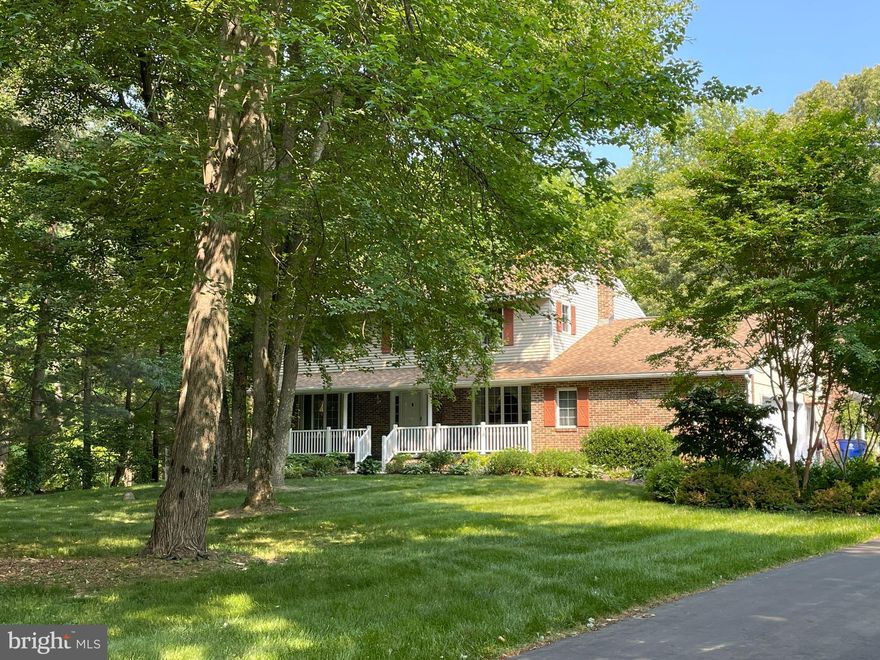 Beautiful well-maintained home in Woodcrest Shores, a water-oriented community. Everything you need is right here so bring your boat, kids and toys! This colonial is well appointed with 4 bedrooms, 3 baths, 2 car detached garage with storage above, large kitchen with pantry, Huge Living room, Oversized family room with raised hearth fireplace leads to a huge 3 season screened porch with hot tub that stays! Awnings on Southwest windows, Inground gunite and tile pool with concrete patio and diving board, back yard is full of amazing gardens, herb and flower gardens, fruits trees and bushes include blueberry, raspberries, cherries and more! This home is a gardener's delight. This property is full of walking paths, a fire pit, huge carport for your boat, RV or extra vehicles. Long Paved Driveway, Shed and Greenhouse too! Home is heated with oil, has AC , water conditioning system, all appliances stay. There is a beautiful front porch for your enjoyment too! Come check this one out, priced below market.