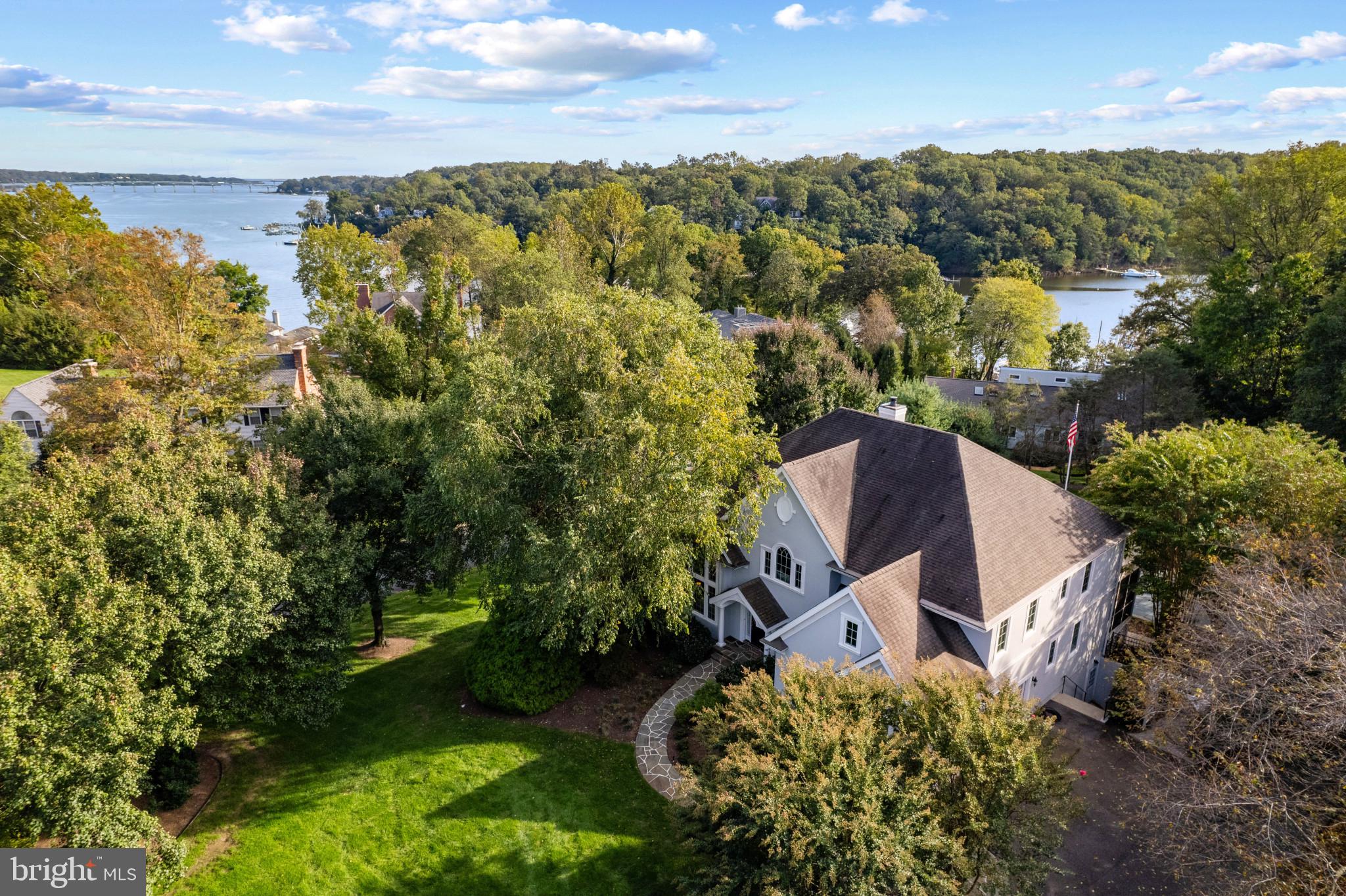 Stunning Colonial home with pool and hot tub in the Downs on the Severn community! This sought after waterfront and water-privileged community is plentiful in amenities including 2 deep water marinas, clubhouse, tennis/pickleball courts and community pool. This amazing home stands proudly on a 1 acre corner lot with water views of the Severn River. Enjoy your private backyard oasis in the refreshing pool and hot tub, lounge under the spacious trellis or gather around the stone fireplace on a chilly fall night. Inside, the interior is unsurpassed with great attention to detail, gleaming wood floors, cozy fireplaces, main level ensuite bedroom, screened porch and expansive deck on 2 levels. The 2 story Living room is flooded with natural light and the adjoining dining room couples up for a perfect entertaining area. The gourmet Kitchen with adjacent family room is the ideal space for hosting gatherings big and small. Head upstairs to experience the generously sized bedrooms including the luxurious Primary suite that boasts water views, doubled sided fireplace with sitting area/library and a gorgeous spa-like bathroom with soothing gray and white color scheme. The fully finished lower level offers additional living space and guest room with ensuite bath and separate entrance and the wine cellar, bonus room and wet bar are icing on the cake! Completing this magnificent property is lush mature landscaping, 2 car garage and a wonderful community filled with amenities. Don't let this opportunity pass you by! Welcome Home!