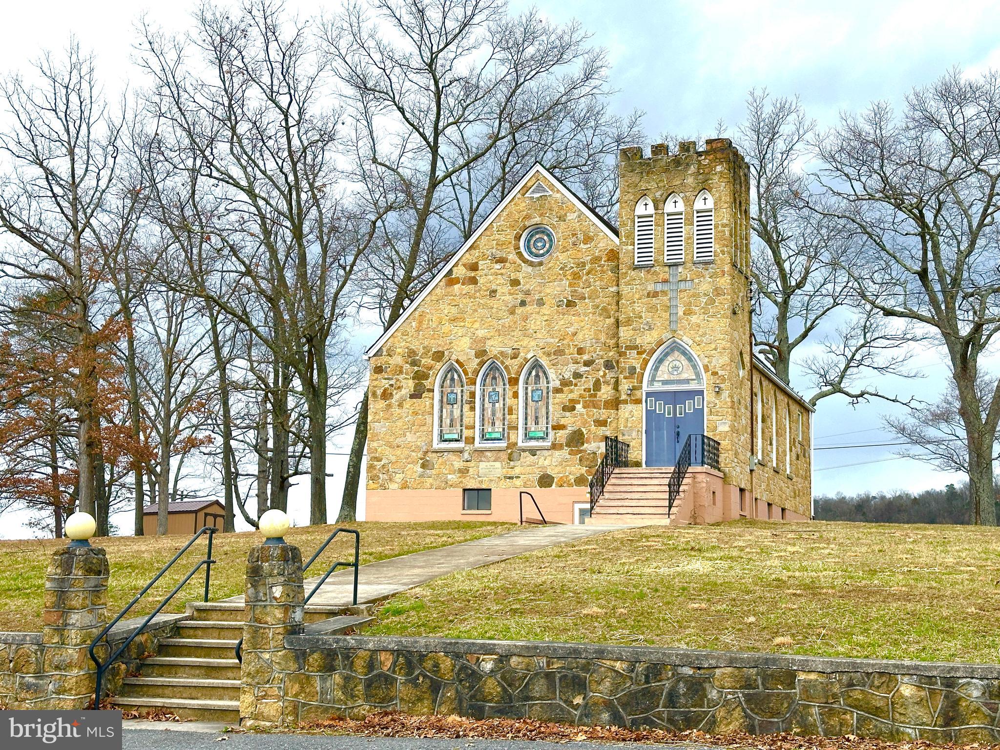 Built in 1949, this nearly 3000-sf stone church has an upper-level entrance foyer and a well-maintained sanctuary with pew seating for approximately 100. Interior stairs connect the sanctuary to the lower level, which includes a hall, kitchen, restrooms, furnace room, and storage. There are exterior access points to the lower level but no ADA-compliant access. The building is heated by a fuel oil-fired furnace, which has been operational throughout the winter season. There is also central air, but the system's condition is unknown. There are no apparent roof leaks, but observation from the exterior shows some loose/missing roof shingles. Public records indicate public sewer, but this has yet to be verified by the county. Water is purchased from a neighbor, and delivered to the building. It is unknown whether a well can be drilled on the property; please inquire with the county. Except for the shed in the rear yard, most chattels convey with the sale. The property sale includes two parcels: 1) improved parcel of ±1 acre, and a vacant parcel (to the east) of ±0.19 of an acre (not buildable). While the property is turnkey, some updates and repairs should be expected. Zoning is GU (General Urban), which supports residential and some non-residential uses.
To schedule a tour, please have your real estate professional book through ShowingTime. There is no option to lease the building. The seller has limited knowledge about the property and welcomes buyers to undertake a full inspection. The property will be sold as is; seller will make no repairs. Owner financing may be available for a full-price offer. Commercial loan terms: 30% down, 7.5% interest, amortized over 20 years, 5-year balloon. The seller makes no representation regarding condition, zoning, or use. Buyers should address any issues during the study period.
To submit an LOI, please request a term sheet. The seller has its own commercial purchase agreement and its own closing agent. Buyer to pay all closing costs. There is no seller concession. This is a commercial sale.