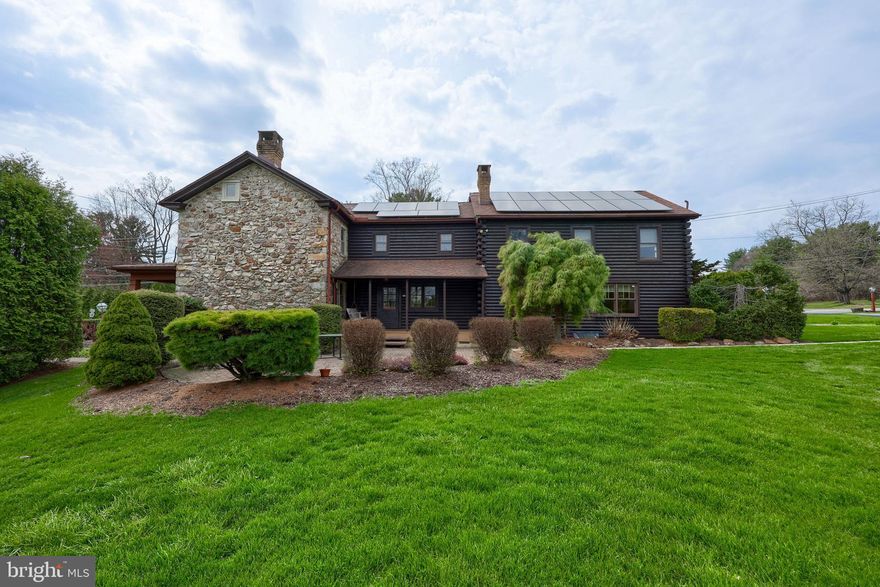 Settle your family into this extraordinary stone and log residence within the Oley school district. Spanning 3,224 square feet, the original part of the home was built in1860 and offers distinctive built-ins, deep window sills, and a walk-in fireplace anchoring the main family room. Picture yourself gathering with loved ones in a bright kitchen featuring an island, granite countertops, and 34 handle kitchen cabinets. The eat-in area connects to a spacious living room measuring 27 by 23 feet, which also houses a laundry room and one of three full bathrooms.
Upstairs, accessible via two staircases, you'll find five bedrooms and two full baths. There is an extra room perfect for use as an office or children's playroom. The master suite is large enough for a cozy sitting corner, with its bathroom boasting of a charming claw-foot bathtub. Throughout the second floor, numerous windows let in abundant natural light.
The basement stretches across the entire footprint of the house, and is divided into three sections. Entering from the stone portion of the hous, reveals a well pump, a newer oil burner for secondary heating, an above-ground oil tank, and a 200-amp electrical panel. Most of the space serves as storage, while the central section is ideal for household projects and includes a unique spring cellar. At the rear of the basement, there's a finished 21-by-21-foot entertainment room, along with two closets containing HVAC units for the geothermal system. Outdoor access to the basement is provided by a Bilko door and another entry from the side porch.
Situated on a 1.62-acre lot, the home features a covered porch at the front and side, a generous brick patio, hot tub, and a two-car garage, with the well found beside the garage. Mature trees, shrubs, and plenty of open space offer opportunities for gardening and outdoor gatherings, making this home both inviting and functional.